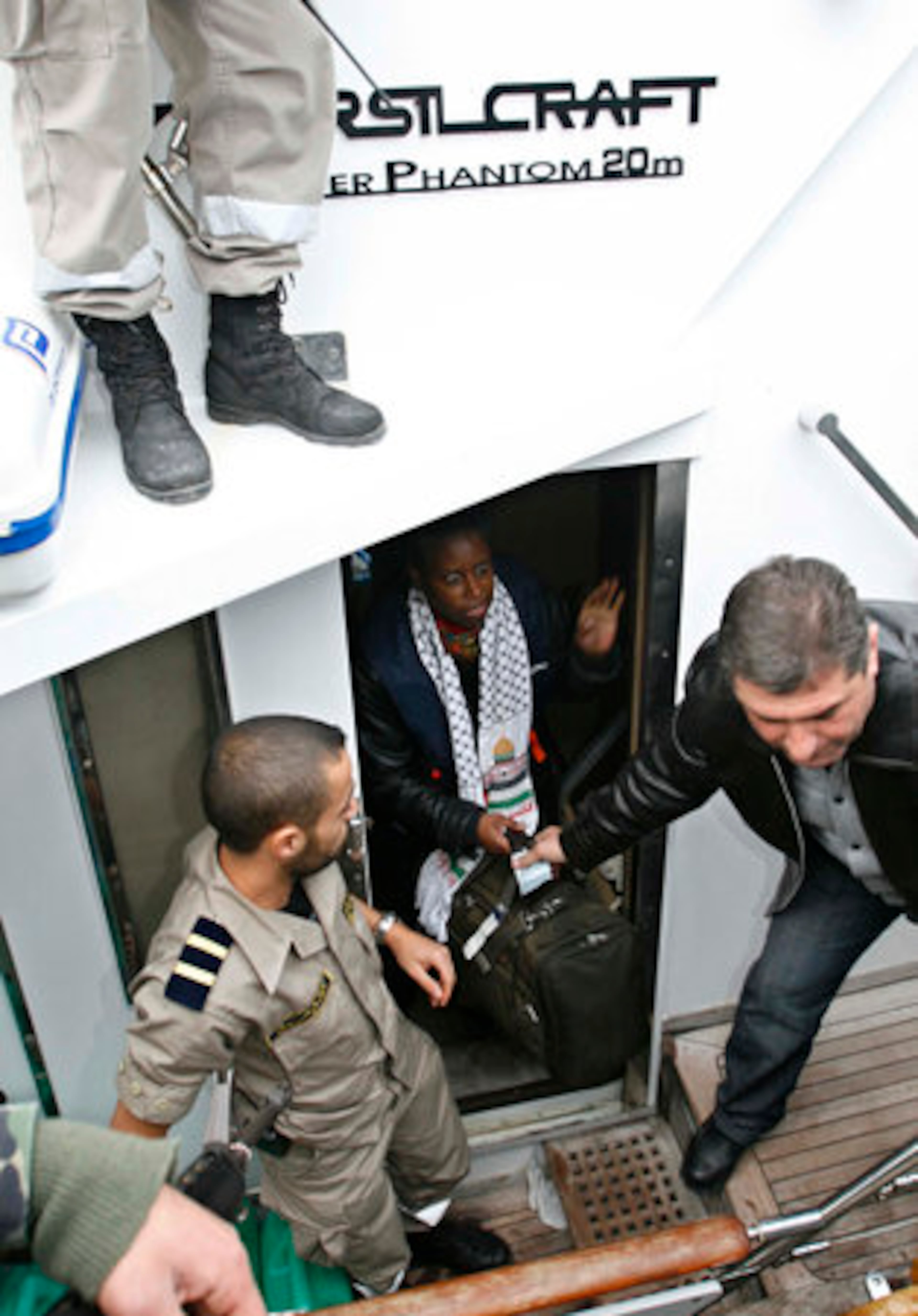 Former U.S. congresswoman Cynthia McKinney, center, is helped out of the vessel SS Dignity, from the group Free Gaza, as it arrives in the southern port city of Tyre, Lebanon, Tuesday, Dec. 30, 2008. The boat, carrying international peace activists and medical supplies to the embattled Gaza Strip, arrived back into Tyre Tuesday - after being turned back and damaged by the Israeli navy, according to the organizers of the trip.