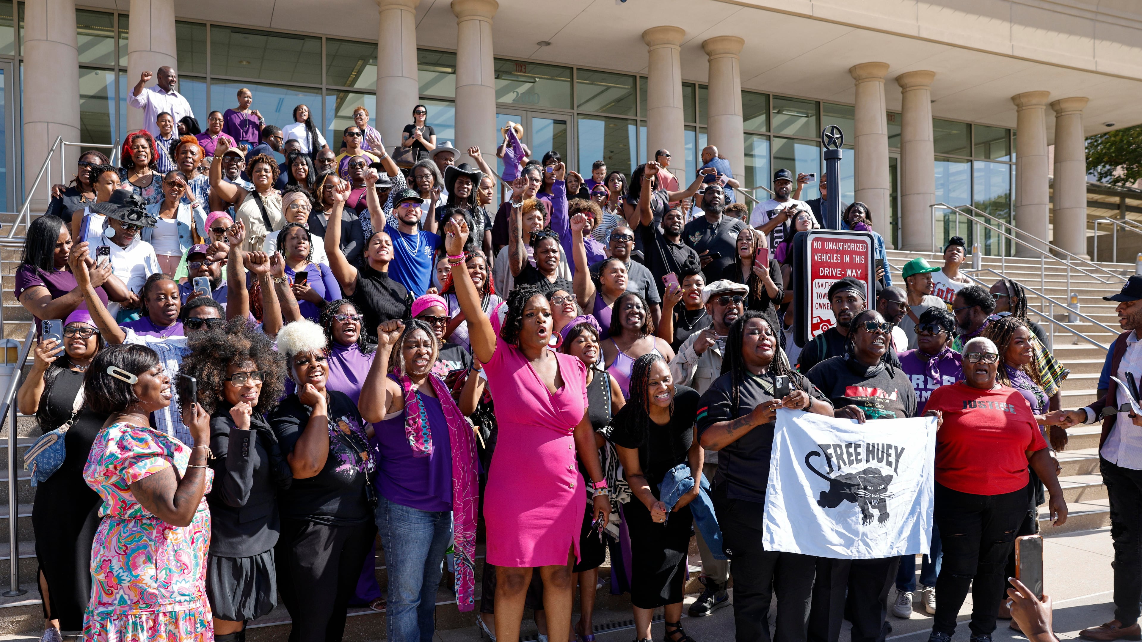 Supporters of Karmelo Anthony chant as they pose for photos outside the Collin County Courthouse after Judge John Roach Jr. was recused from the next phase of Anthony's murder trial, Wednesday, Aug. 19, 2026, in McKinney, Texas. (Elías Valverde II/The Dallas Morning News via AP)