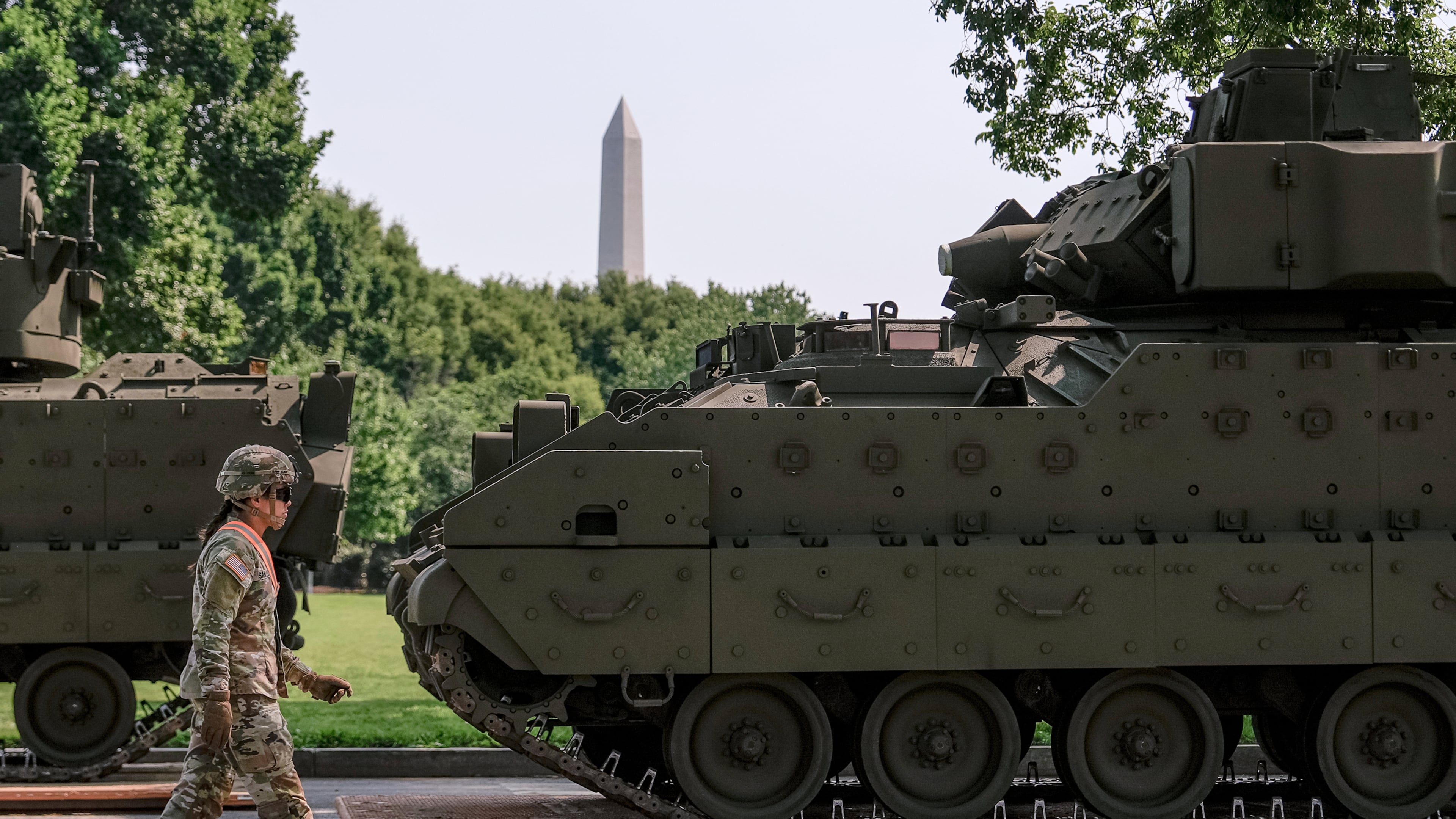 FILE - A U.S. Army soldier walks past a Bradley fighting vehicle staged in West Potomac Park ahead of an upcoming military parade commemorating the Army's 250th anniversary and coinciding with Donald Trump's 79th birthday, June 11, 2025, in Washington. (AP Photo/Julia Demaree Nikhinson, File)