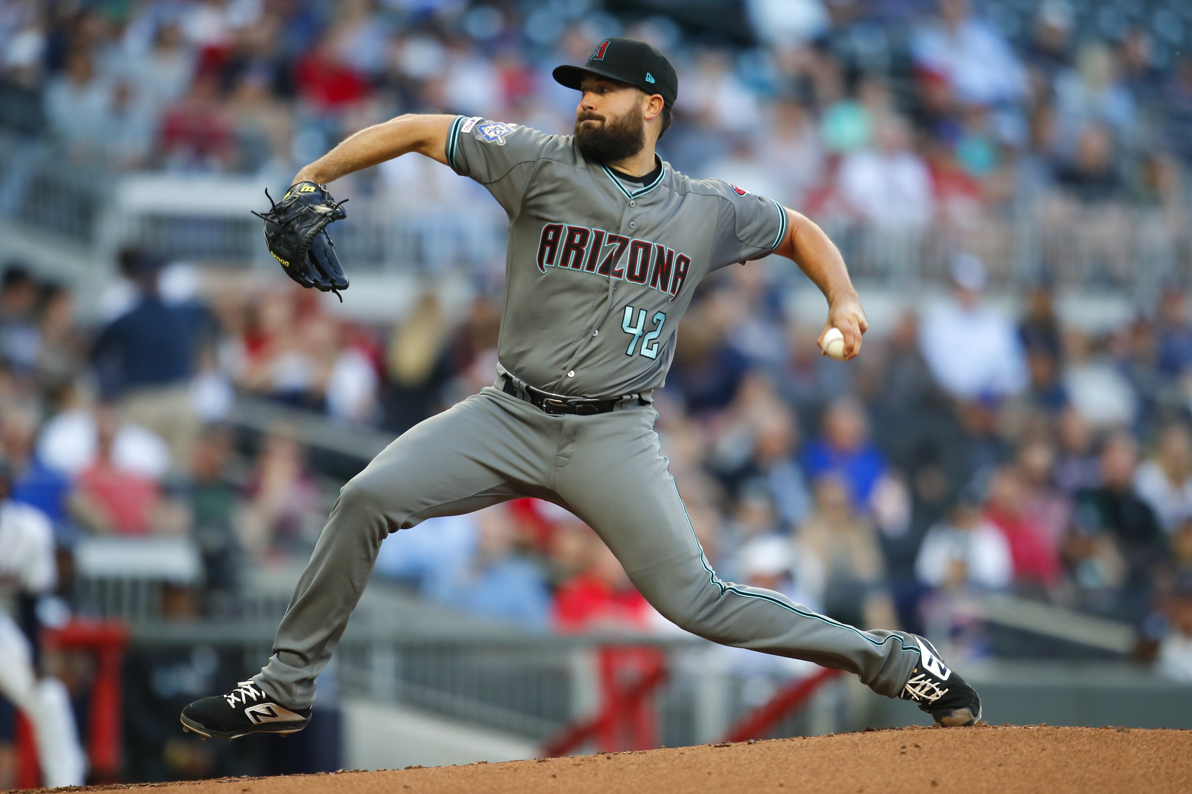 ATLANTA, GA - APRIL 16: Robbie Ray #38 of the Arizona Diamondbacks delivers in the first inning of an MLB game against the Atlanta Braves at SunTrust Park on April 16, 2018 in Atlanta, Georgia. All players are wearing number 42 to honor Jackie Robinson. (Photo by Todd Kirkland/Getty Images)