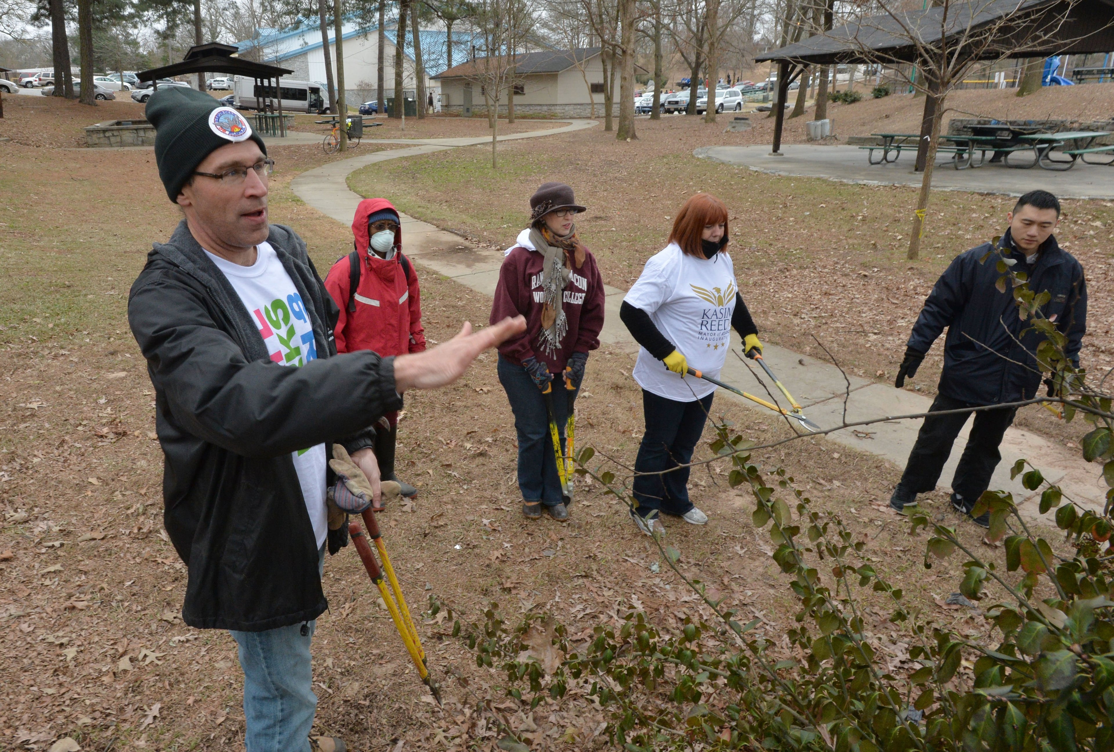 Commissioner George Dusenbury works on trimming bushes during a community service project, which was a part of then-Mayor Kasim Reed's inauguration schedule of events, at Washington Park in Atlanta on Jan. 4, 2014. (Courtesy)
