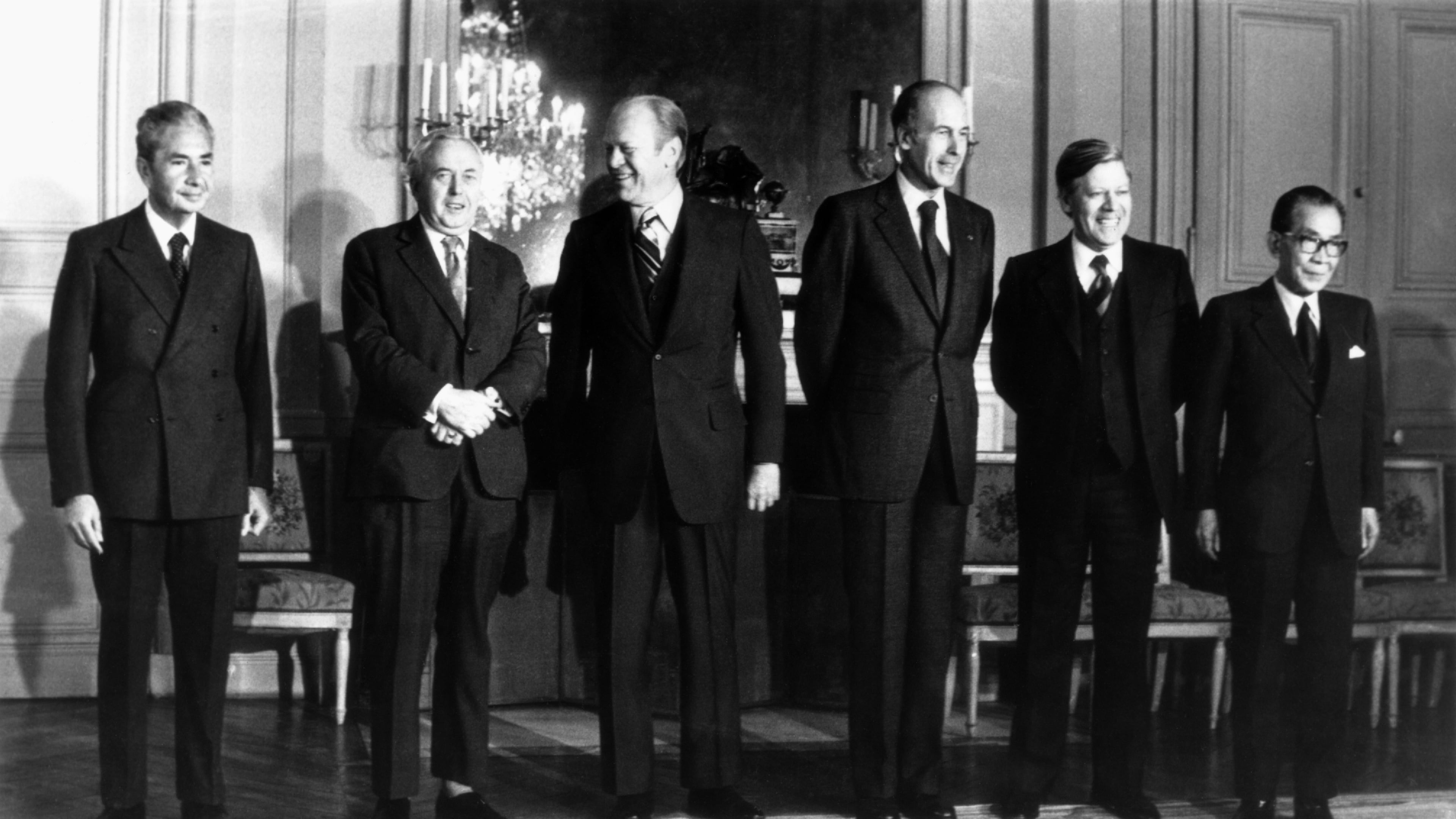 FILE - From left: Premier Aldo Moro of Italy, Premier Harold Wilson of the Great Britain, President Gerald Ford of the United States, President Valery Giscard d'Estaing of France, Chacellor Helmut Schmidt of West Germany and Premier Takeo Miki of Japan, the six heads of state and government, pose for a group portrait during the Economic and Monetary summit meeting at the Chateau de Rambouillet, West of Paris, Nov. 17, 1975. (AP Photo, File)