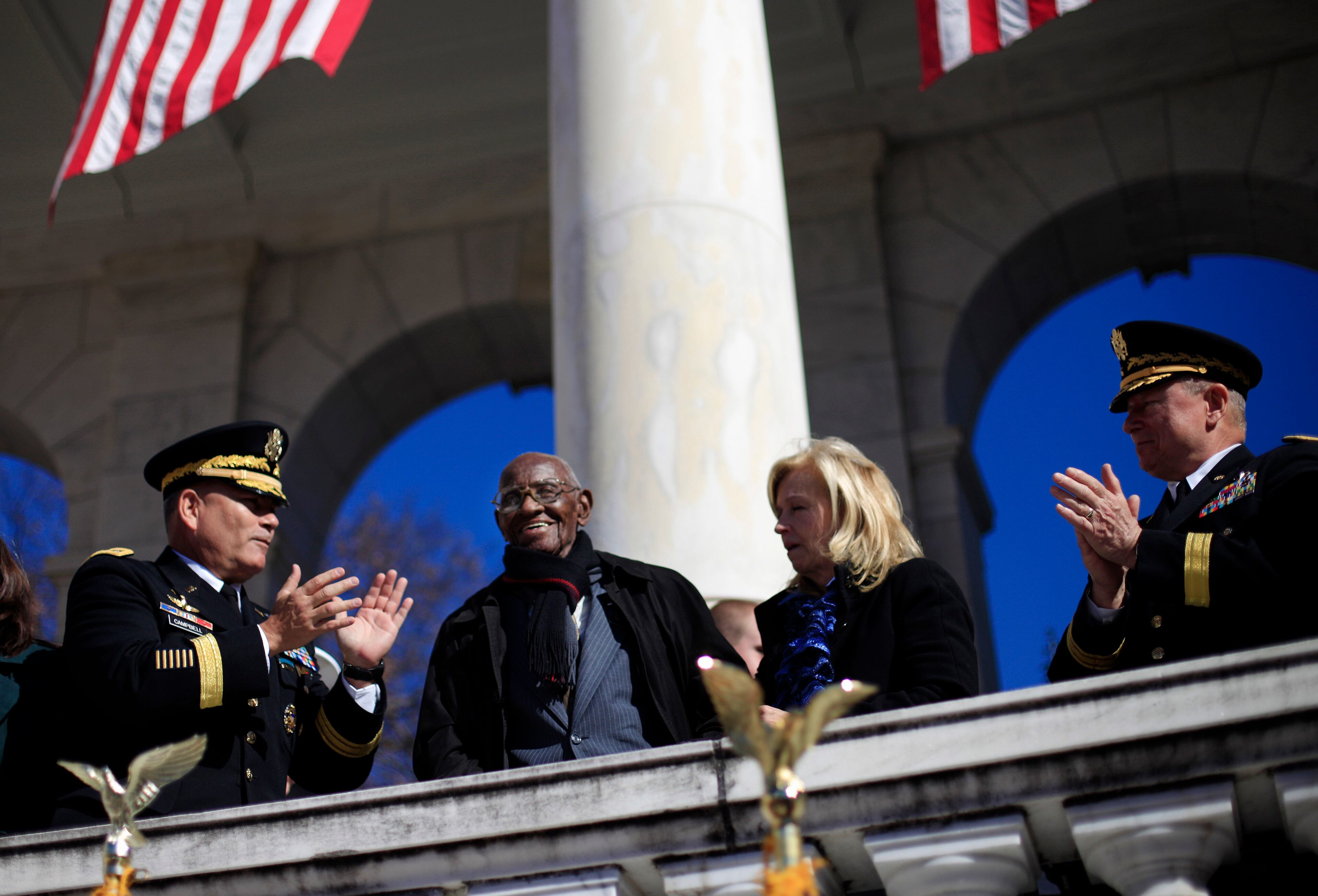 World War II veteran 107 year-old Richard Overton, from East Austin, Texas, center, stands up as he is acknowledge by President Barack Obama during the president's speech at Veteran Day ceremony, Monday, Nov. 11, 2013, at the Arlington National Cemetery Amphitheater in Arlington, Va. The president paid tribute to those who have served in the nation's military, including one of the nation's oldest veterans, the 107-year-old Overton of East Austin, Texas. (AP Photo/Pablo Martinez Monsivais)