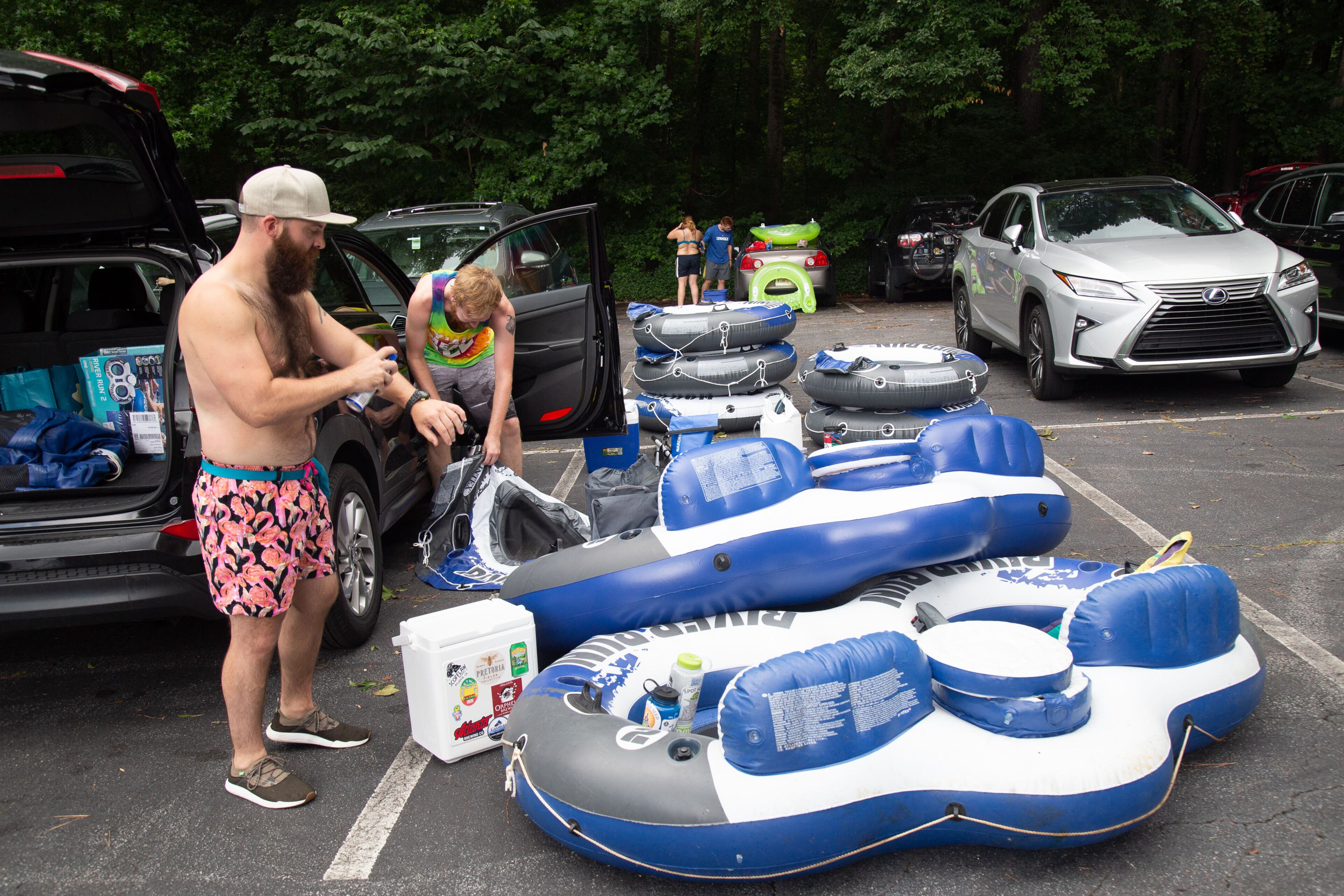 Cameron Alme puts on suntan lotion before heading down the Chattahoochee River at the Powers Island Park in Sandy Springs on Sunday, June 28, 2020. STEVE SCHAEFER FOR THE ATLANTA JOURNAL-CONSTITUTION