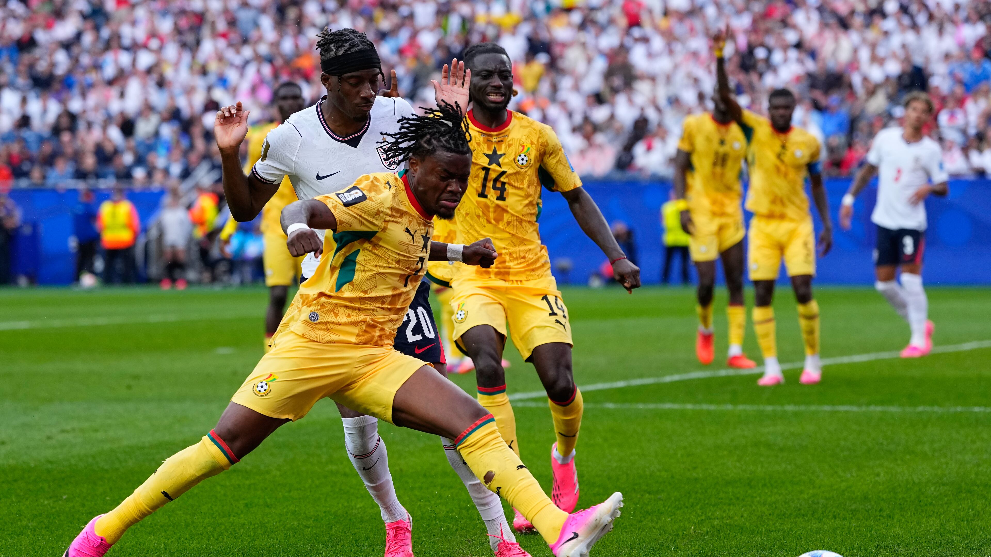 Ghana's Fatawu Issahaku (7) and England's Noni Madueke (20) battle for the ball during the World Cup Group L soccer match between England and Ghana in Foxborough, Mass., near Boston, Tuesday, June 23, 2026. (AP Photo/Petr David Josek)