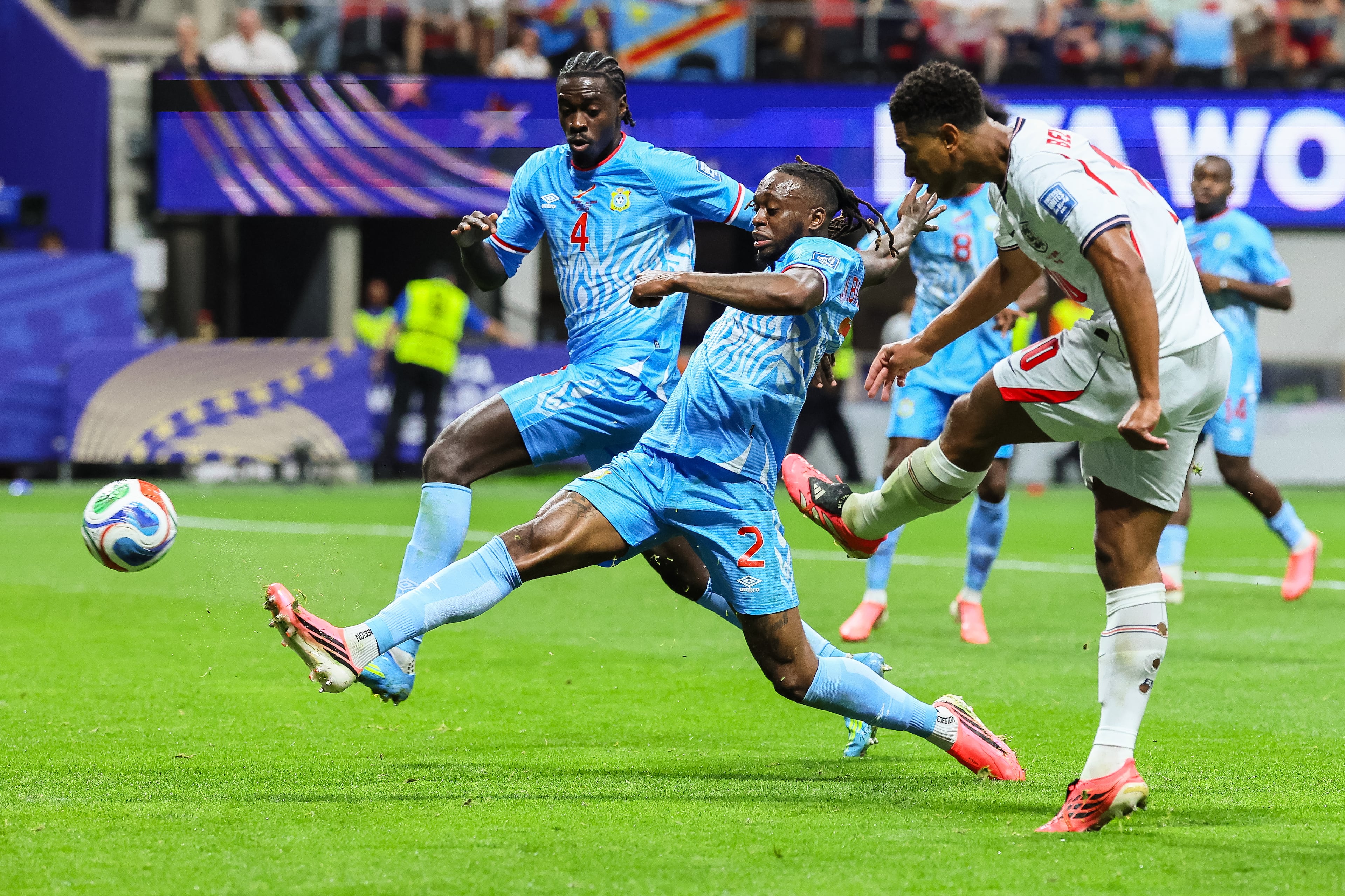 England midfielder Jude Bellingham (right) attempts a kick on goal past Congo defenders Axel Tuanzebe (left) and Aaron Wan-Bissaka (second from left) during the second half of a FIFA World Cup round of 32 match at Atlanta Stadium (Mercedes-Benz Stadium) on Wednesday, July 1, 2026, in Atlanta. (Jason Getz/AJC)