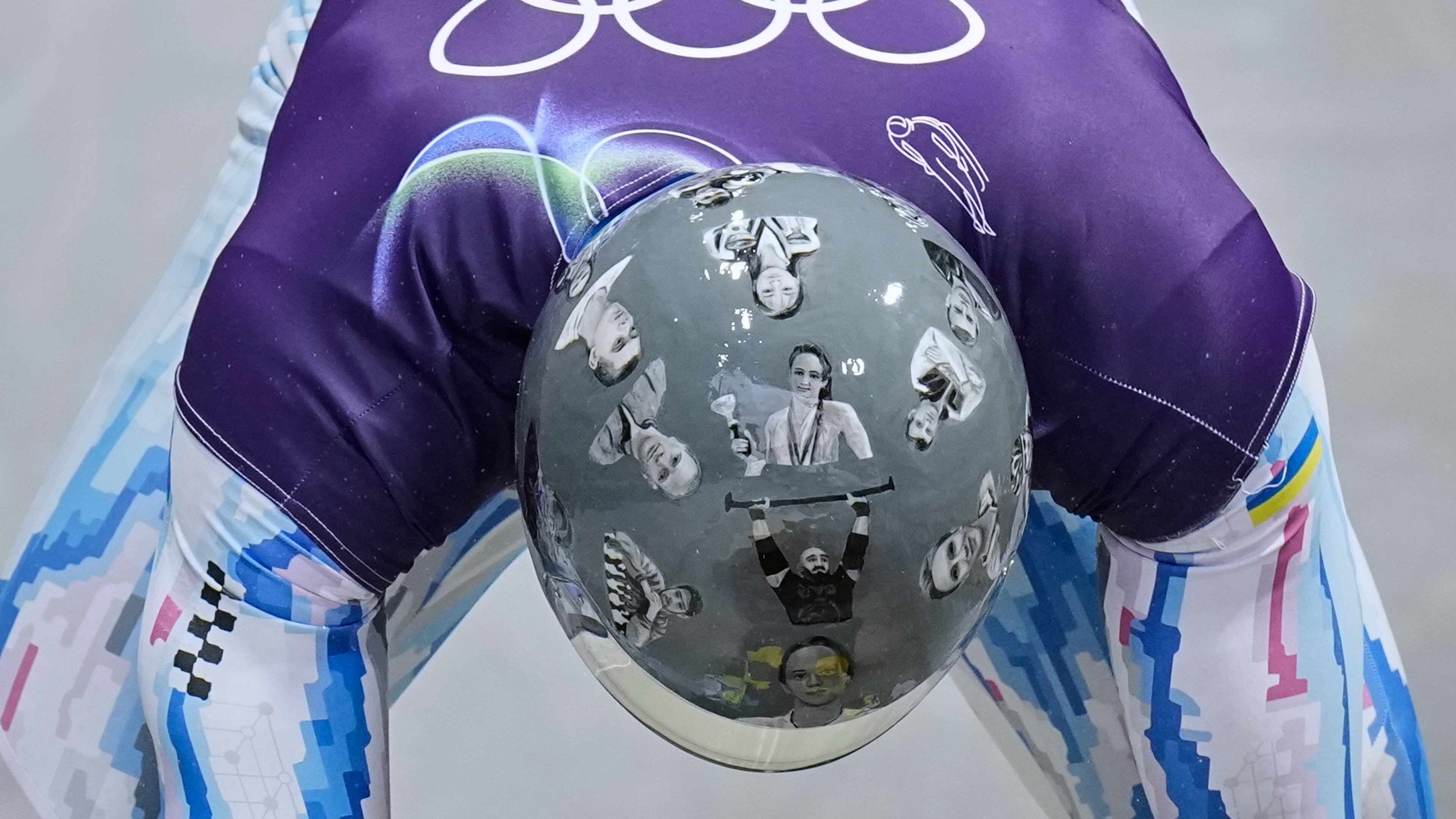 Ukraine's Vladyslav Heraskevych arrives at the finish during a men's skeleton training session at the 2026 Winter Olympics, in Cortina d'Ampezzo, Italy, Tuesday, Feb. 10, 2026. (AP Photo/Alessandra Tarantino)
