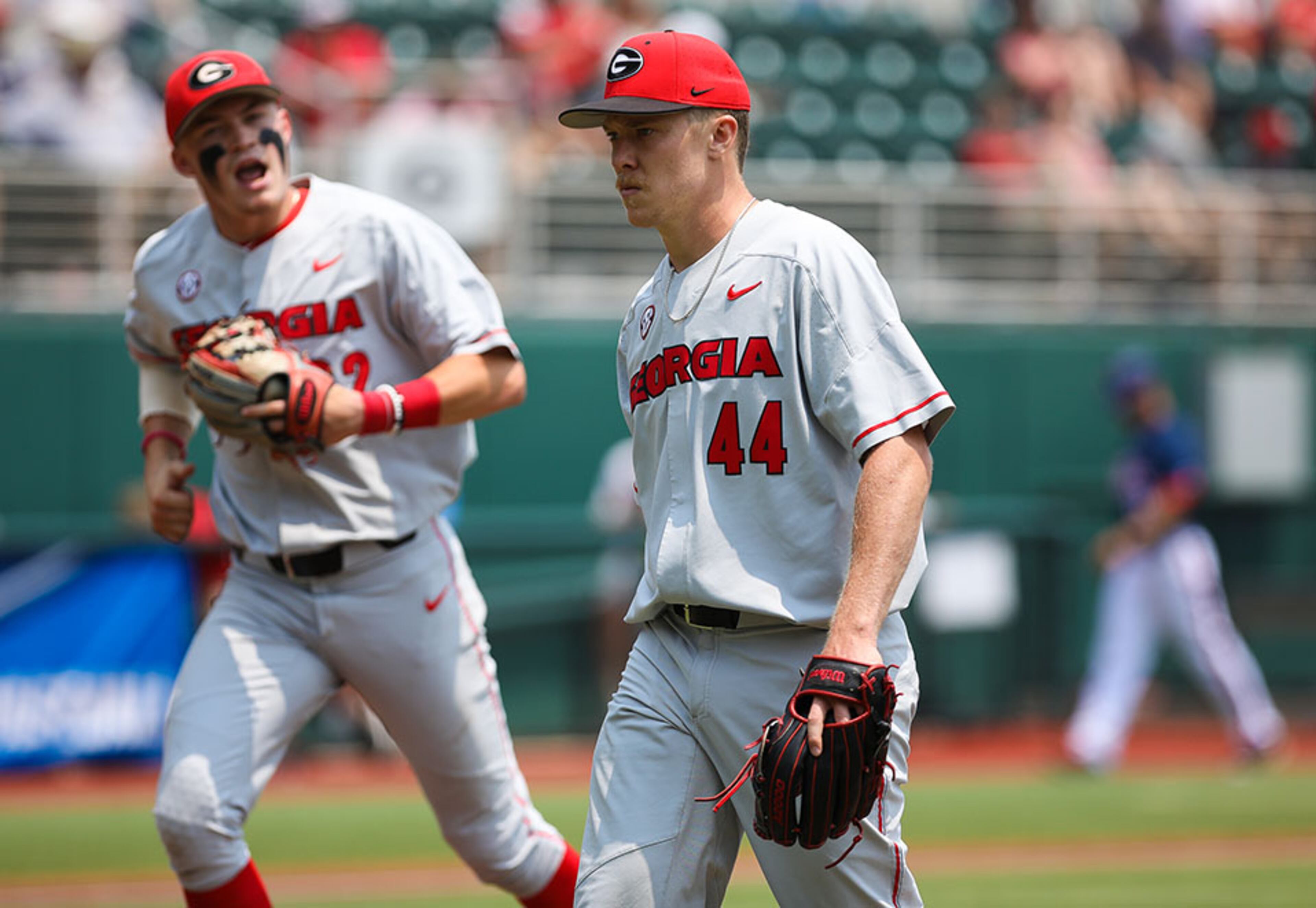 Georgia infielder Aaron Schunk (background) yells after pitcher Tim Elliott (44) during the NCAA regional baseball game against Florida Atlantic Sunday, June 2, 2019, at Foley Field in Athens.