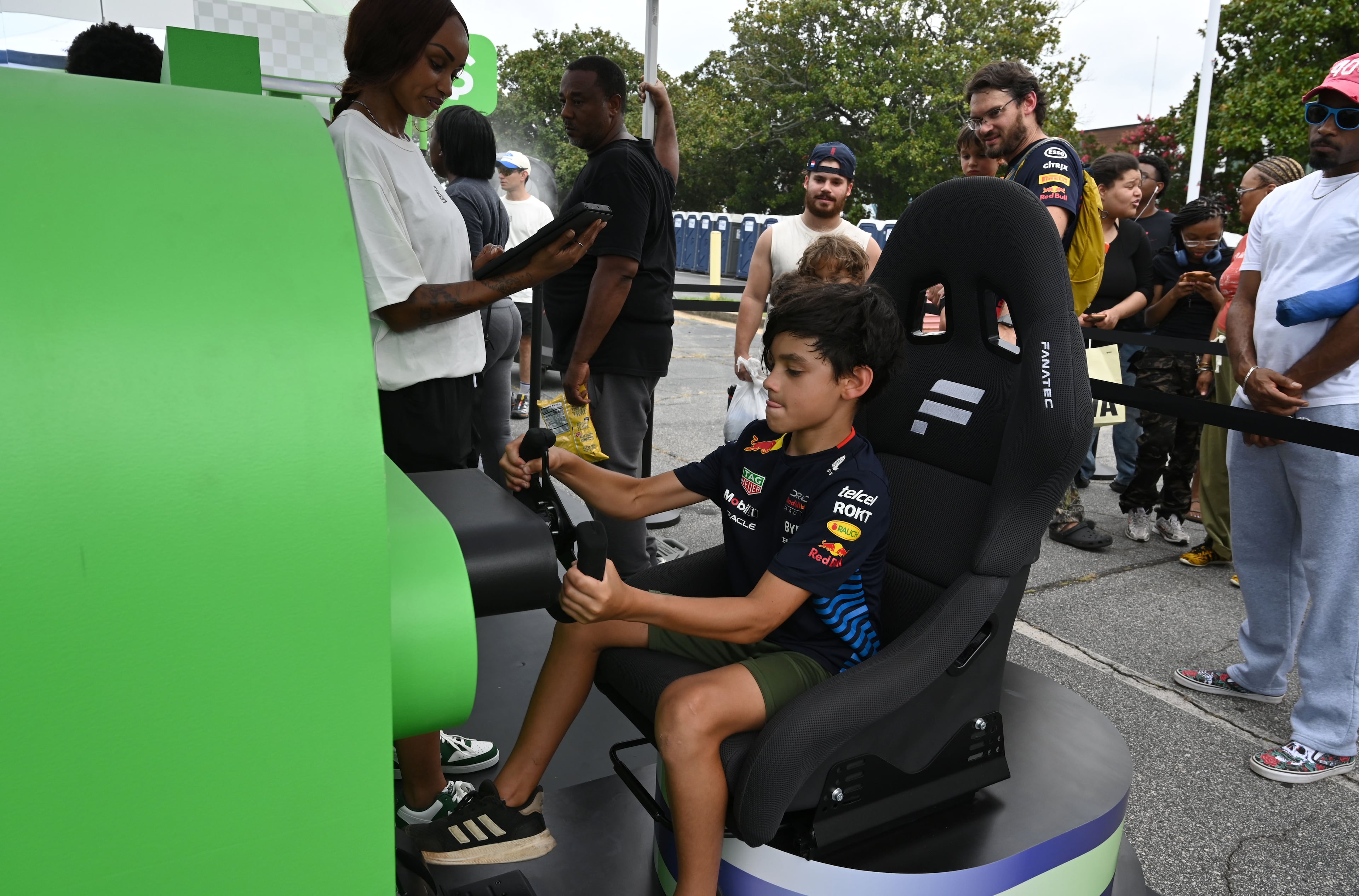 Vincent Avitabile, 9, takes part in a driving simulator experience during the Red Bull Showrun Atlanta Presented by Ford Racing on Saturday, Aug. 1, 2026, in Atlanta. Atlanta city officials this week approved permits for the Red Bull Showrun that will allow the live motorsports demonstration event to go on as advertised along a roughly half-mile stretch of Hank Aaron Drive — a backup location after earlier plans to hold the event near Piedmont Park ran into opposition from Midtown residents. (Hyosub Shin/AJC)