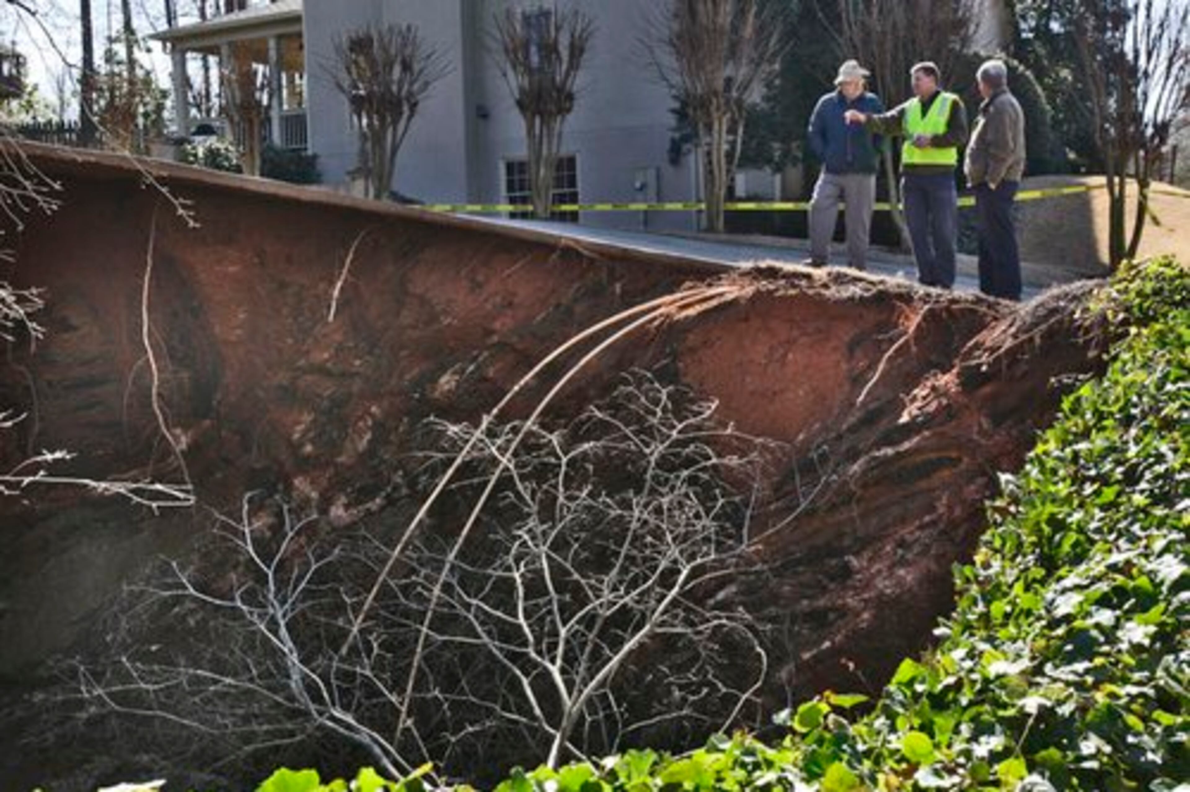 A large sinkhole appeared overnight Monday in the Charlton Trace neighborhood, off Chestnut Hill Road, in Marietta. The sinkhole has undermined the driveway, and is within 18 feet of the roadway.