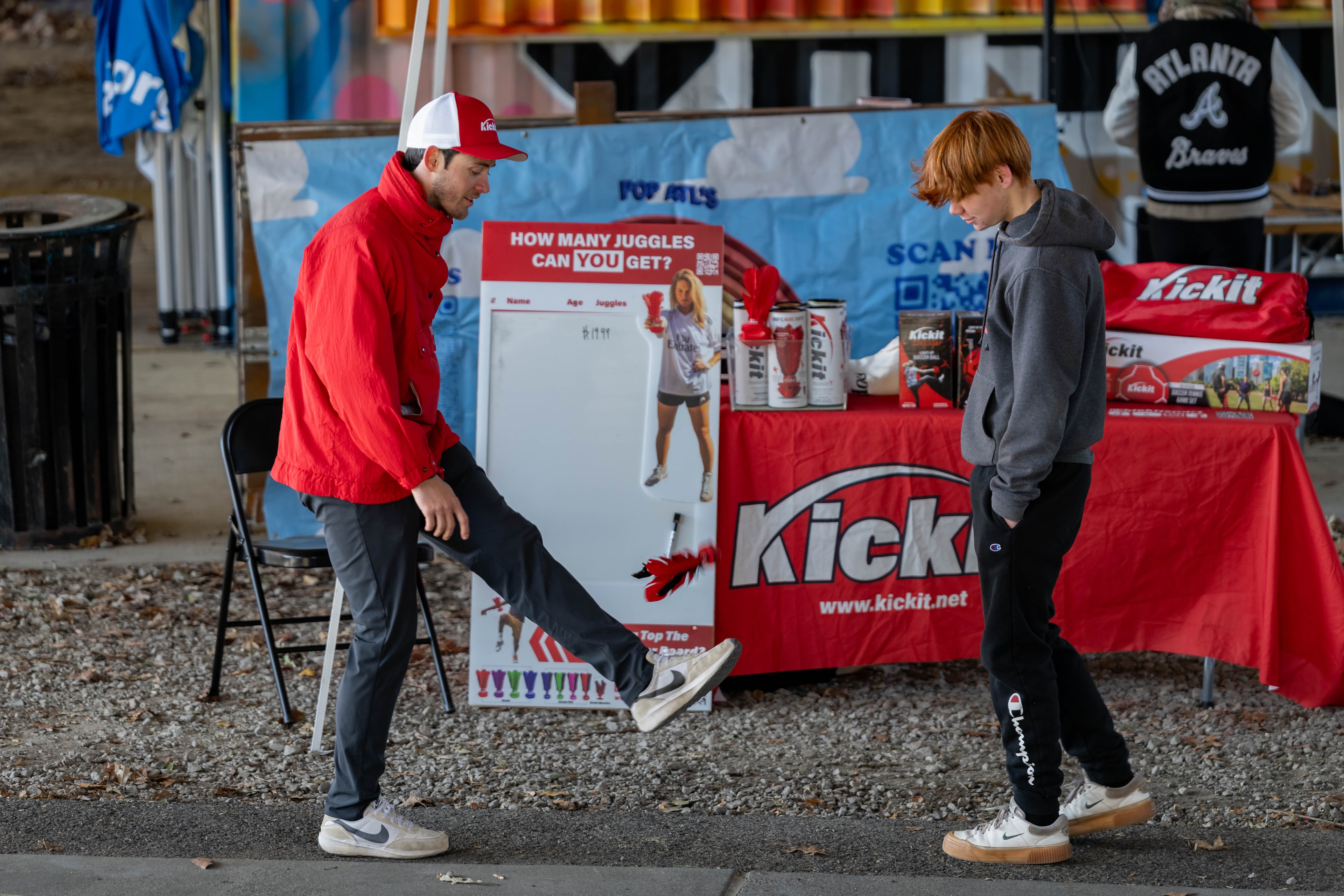 Eli Dent (left) demonstrates his soccer juggling training device at the Atlanta Beltline Marketplace's annual Small Business Saturday event Saturday, Nov. 29, 2025. (Ben Hendren for the AJC)