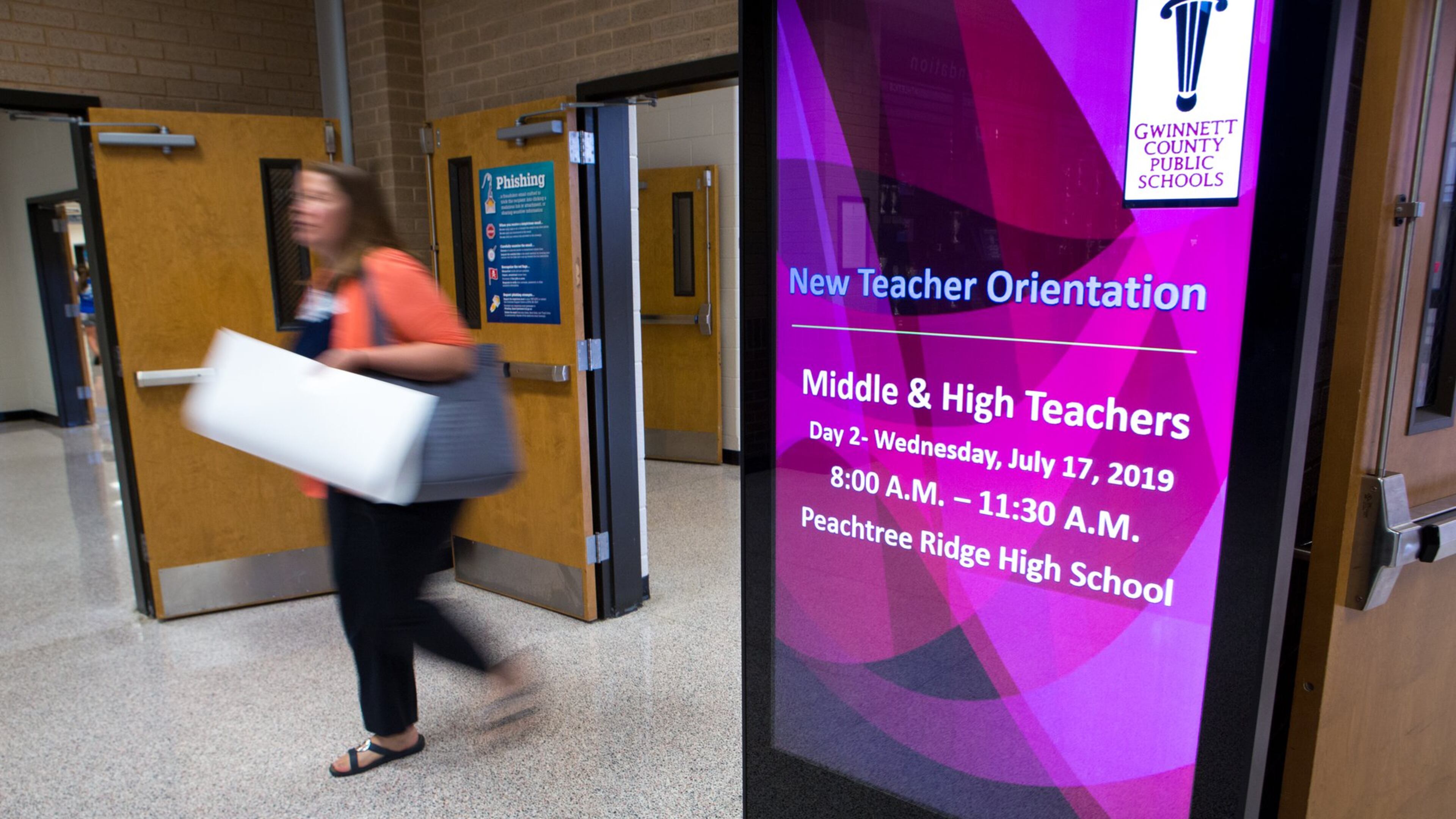 A Gwinnett County Public Schools educator leaves a new teacher orientation at Peachtree Ridge High School in Suwanee on July 17, 2019. CASEY SYKES FOR THE ATLANTA JOURNAL-CONSTITUTION