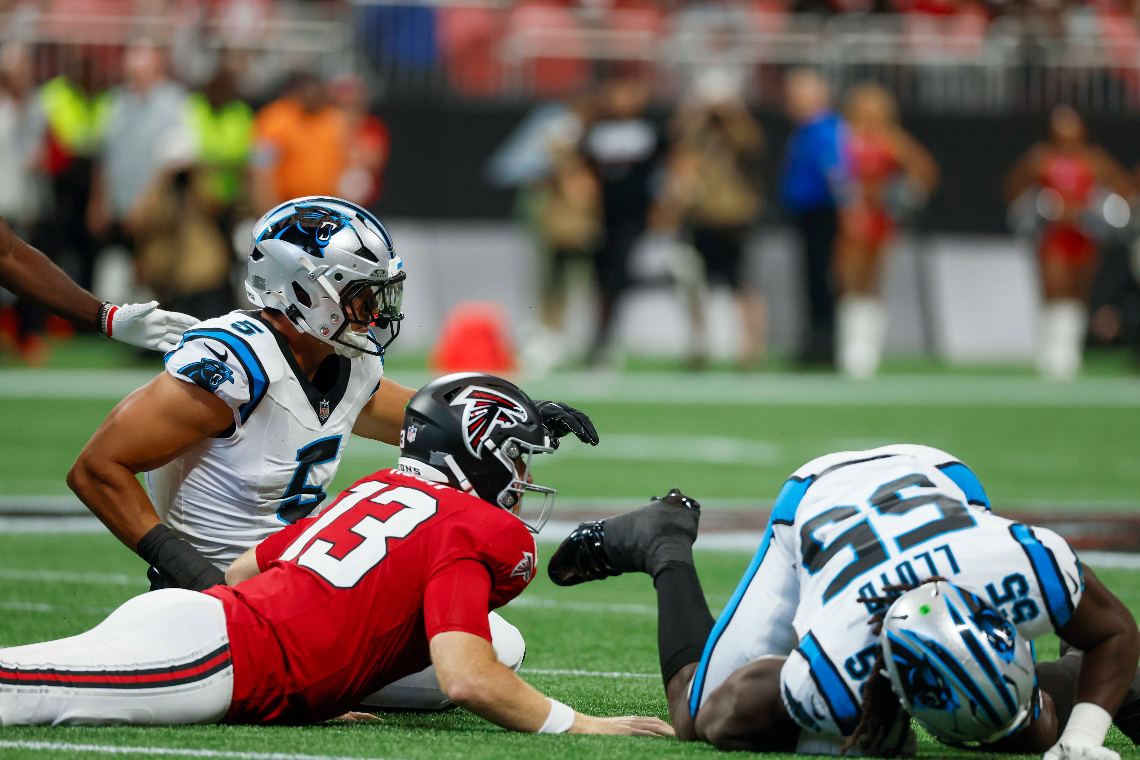 Atlanta Falcons quarterback Cooper Rush (13) watches the ball be stripped for a fumble on his first play of the game, during the first half of an NFL football game against the Carolina Panthers at Mercedes-Benz Stadium in Atlanta on Sunday, September 20, 2026. (Miguel Martinez/AJC)
