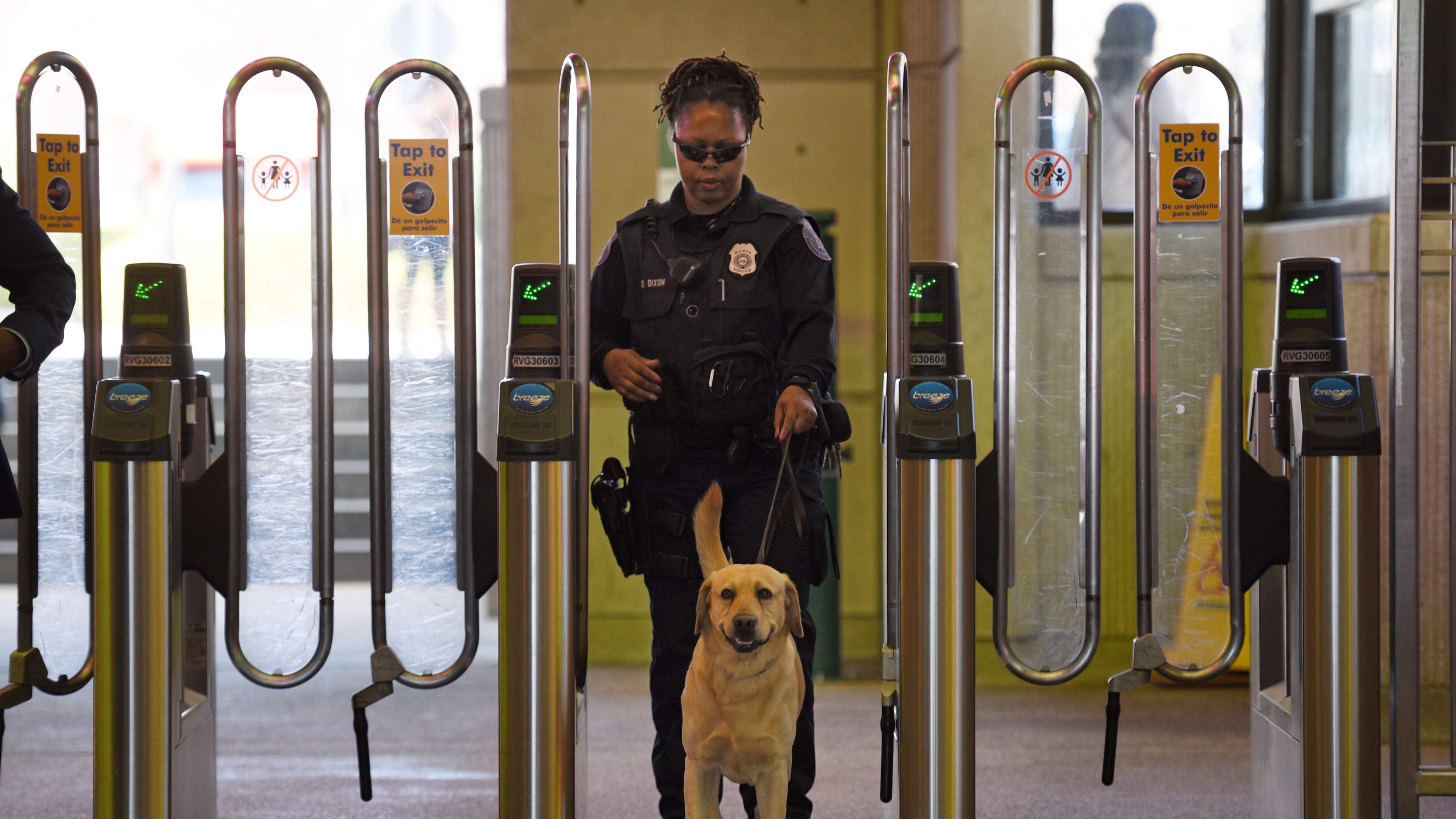 MARTA police K-9 handler Deidre Dixon guides her K-9 at the Lindbergh Center MARTA station.