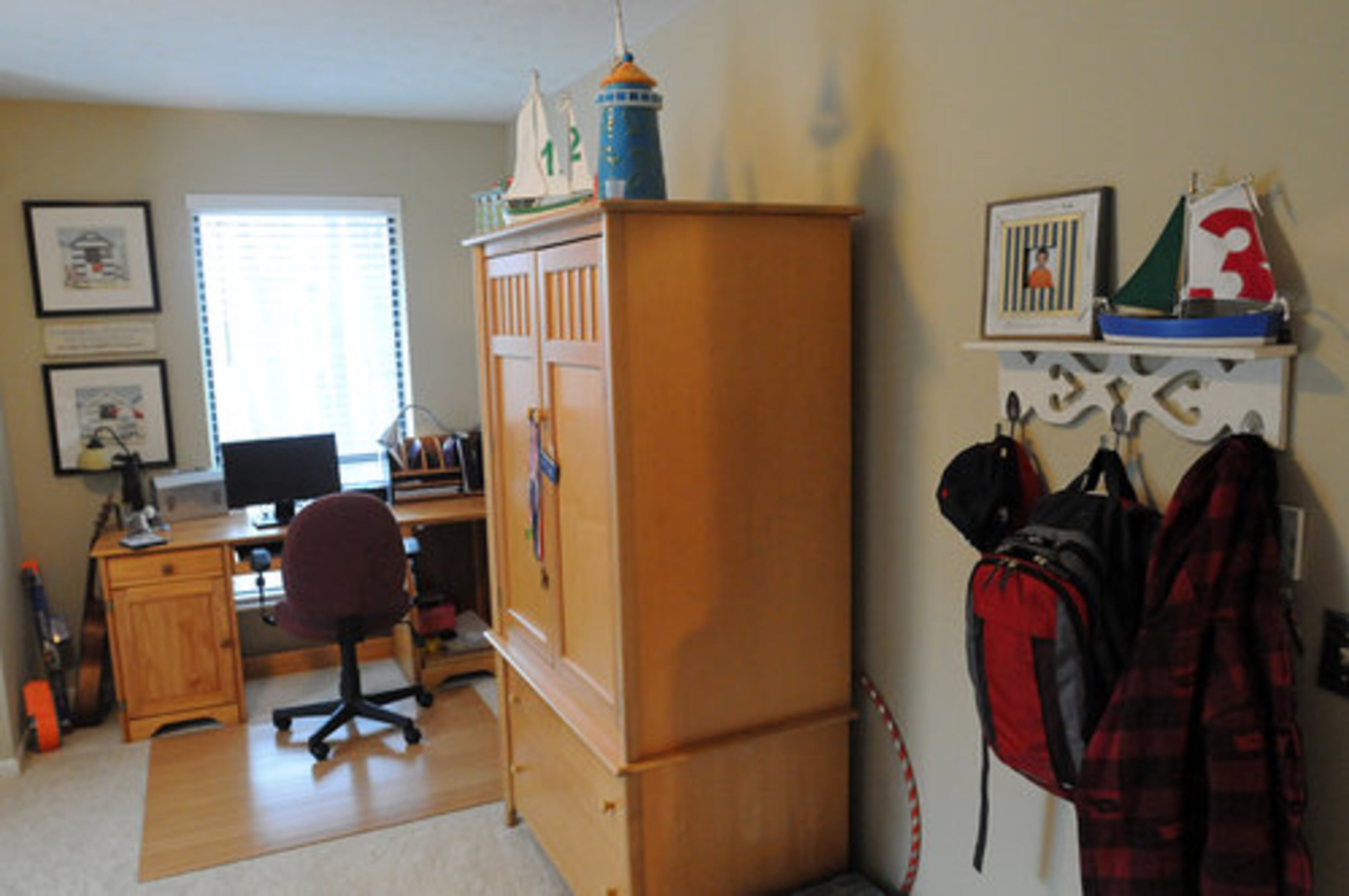 The son's room is playful but also has space for him to work at his desk with a computer.