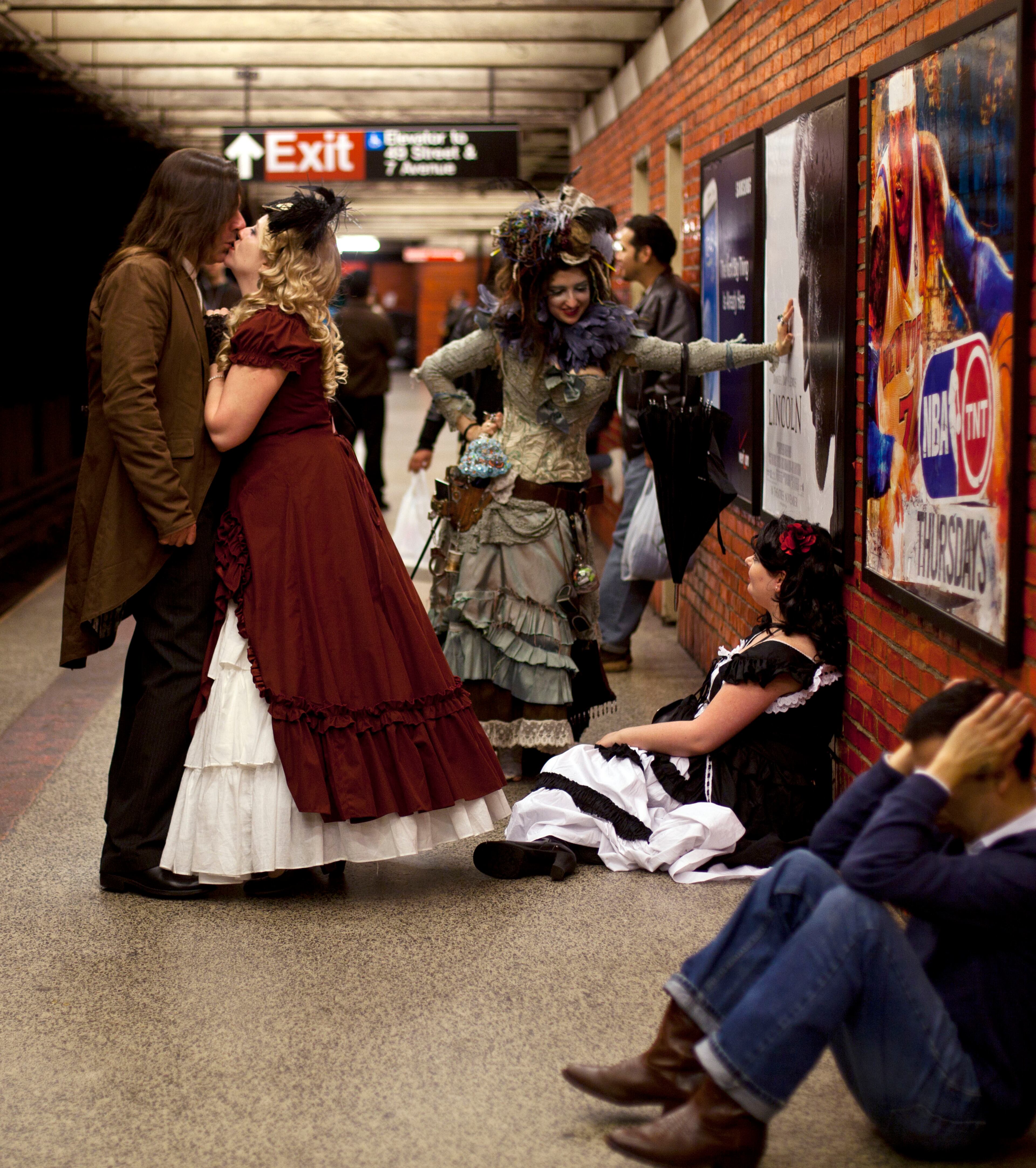 A couple in costume kisses on the platform edge of 49th Street metro station early Sunday, Oct. 28, 2012, in New York, in celebration of Halloween.
