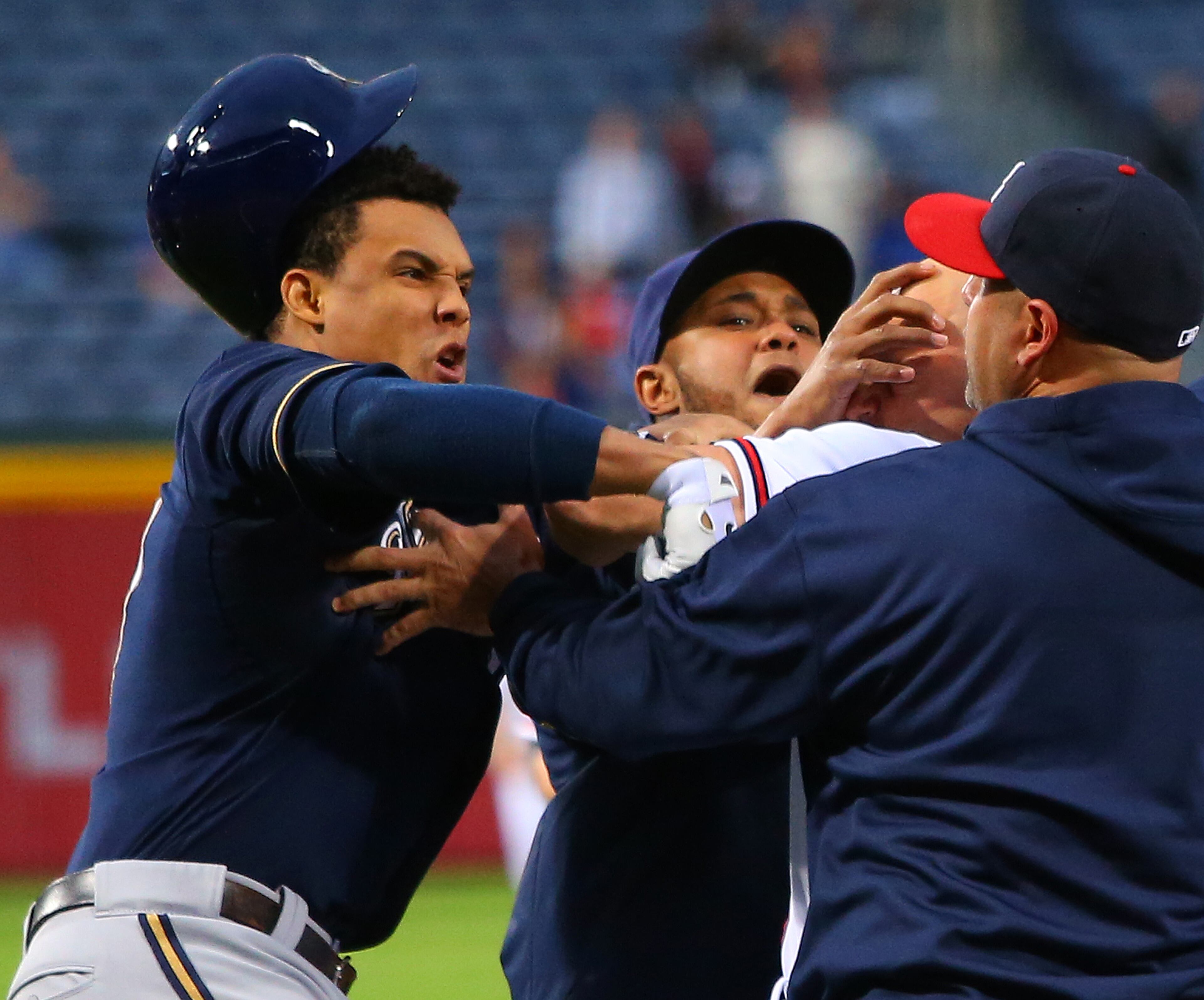 Brewers Carlos Gomez (left) and Braves Reed Johnson (second from right) exchange blows when both benches clear after Braves catcher Brian McCann confronted Gomez for show boating Braves pitcher Paul Maholm on a solo home run during the first inning on Wednesday, Sept. 25, 2013, in Atlanta.