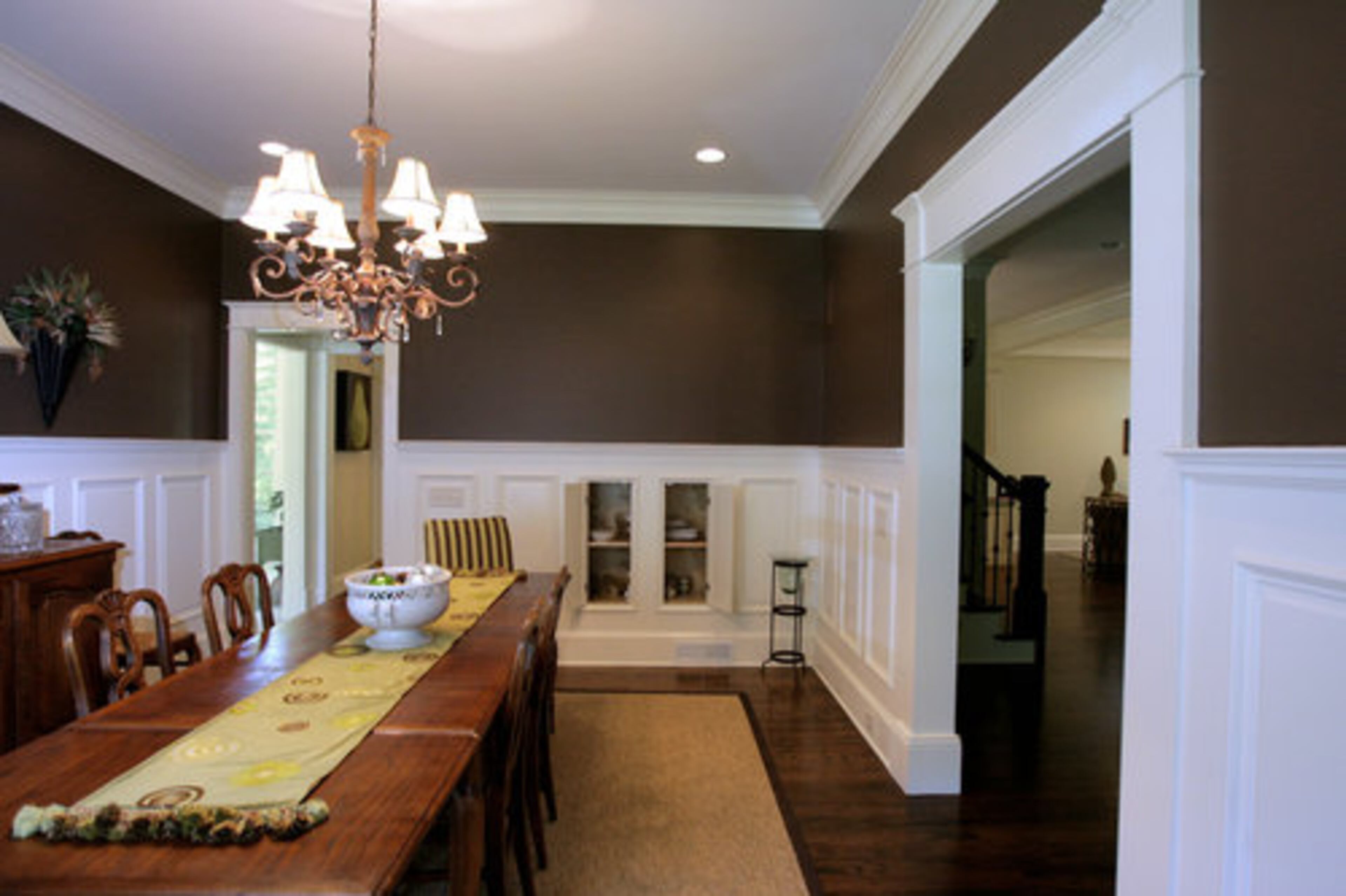 The formal dining room holds a large table, perfect for family gatherings.