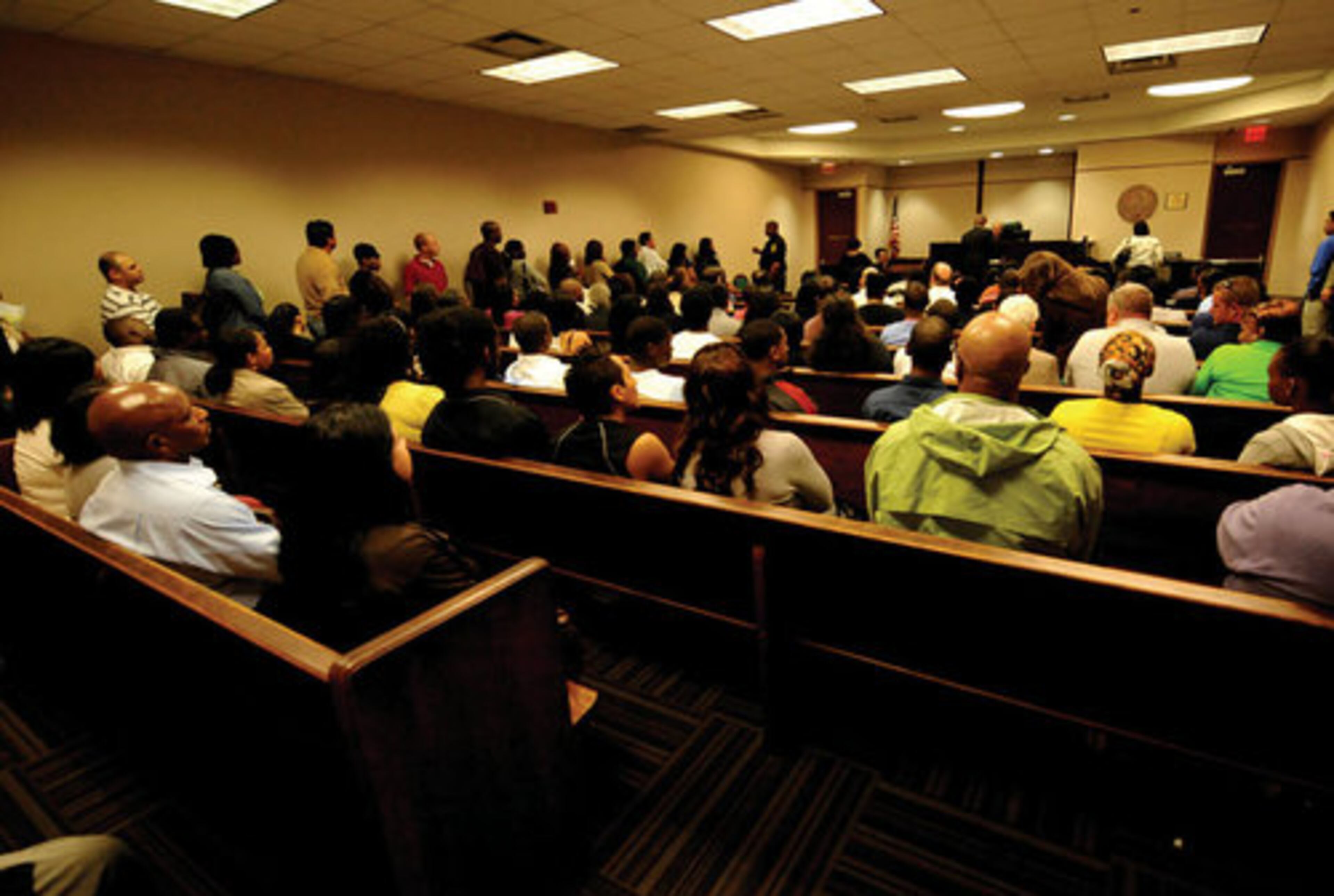 Drivers sit and stand inside a courtroom to pay traffic tickets or to have their day in DeKalb Records Court.