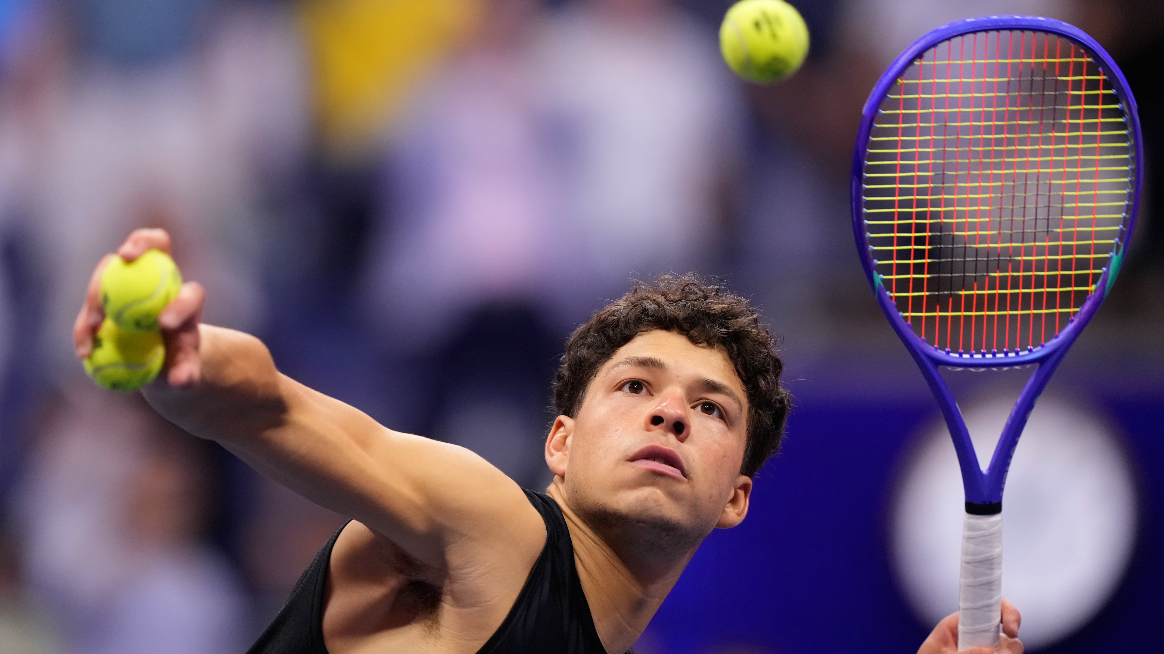 Ben Shelton, of the United States, hits balls to audience after he won his match against Frances Tiafoe, of the United States, during the men's singles semifinals of the U.S. Open tennis championships Friday, Sept. 11, 2026, in New York. (AP Photo/Yuki Iwamura)