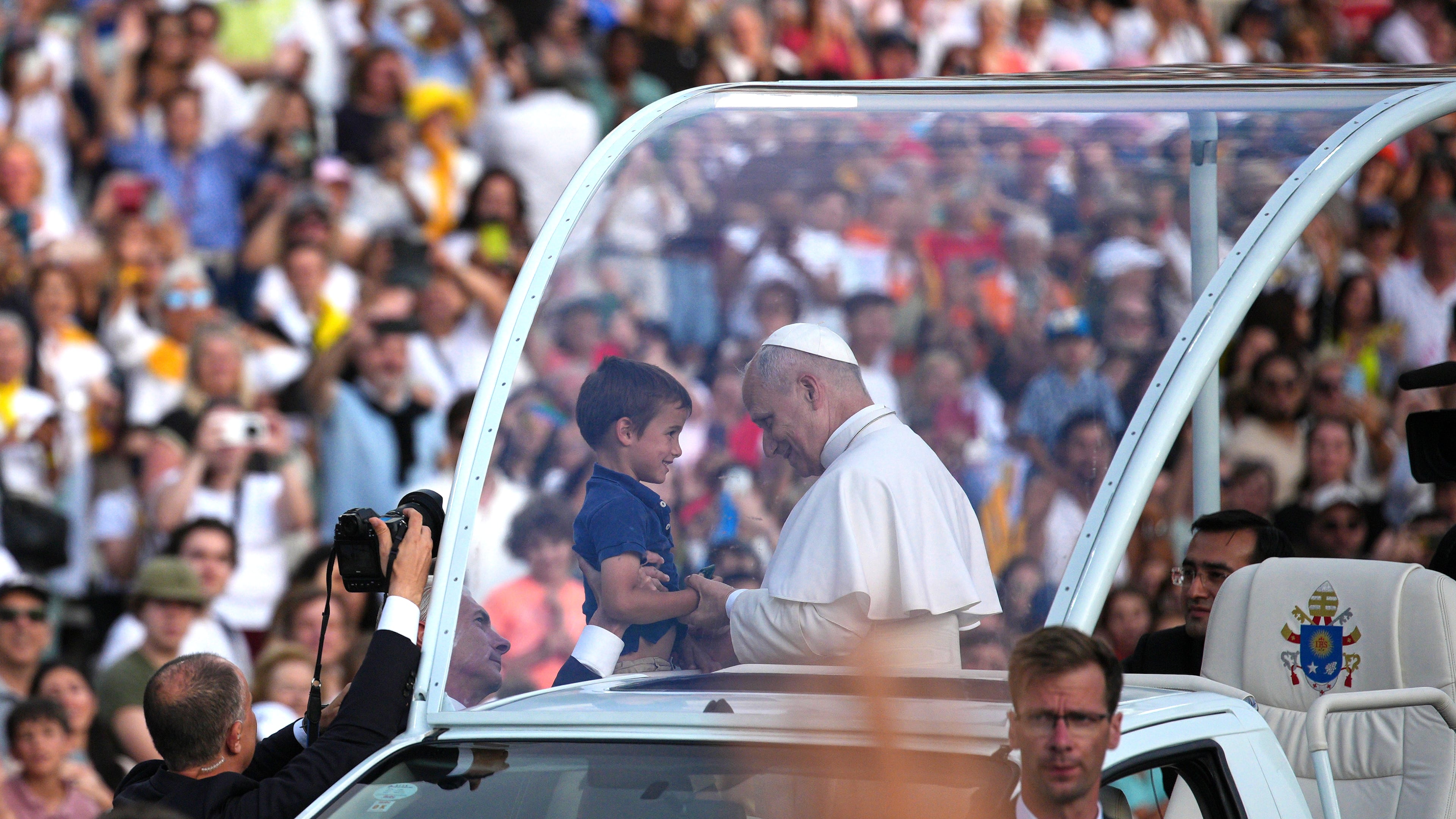 Pope Leo XIV blesses a child before a prayer vigil at Lluis Companys Olympic Stadium in Barcelona, Spain, Tuesday, June 9, 2026. (AP Photo/Emilio Morenatti)