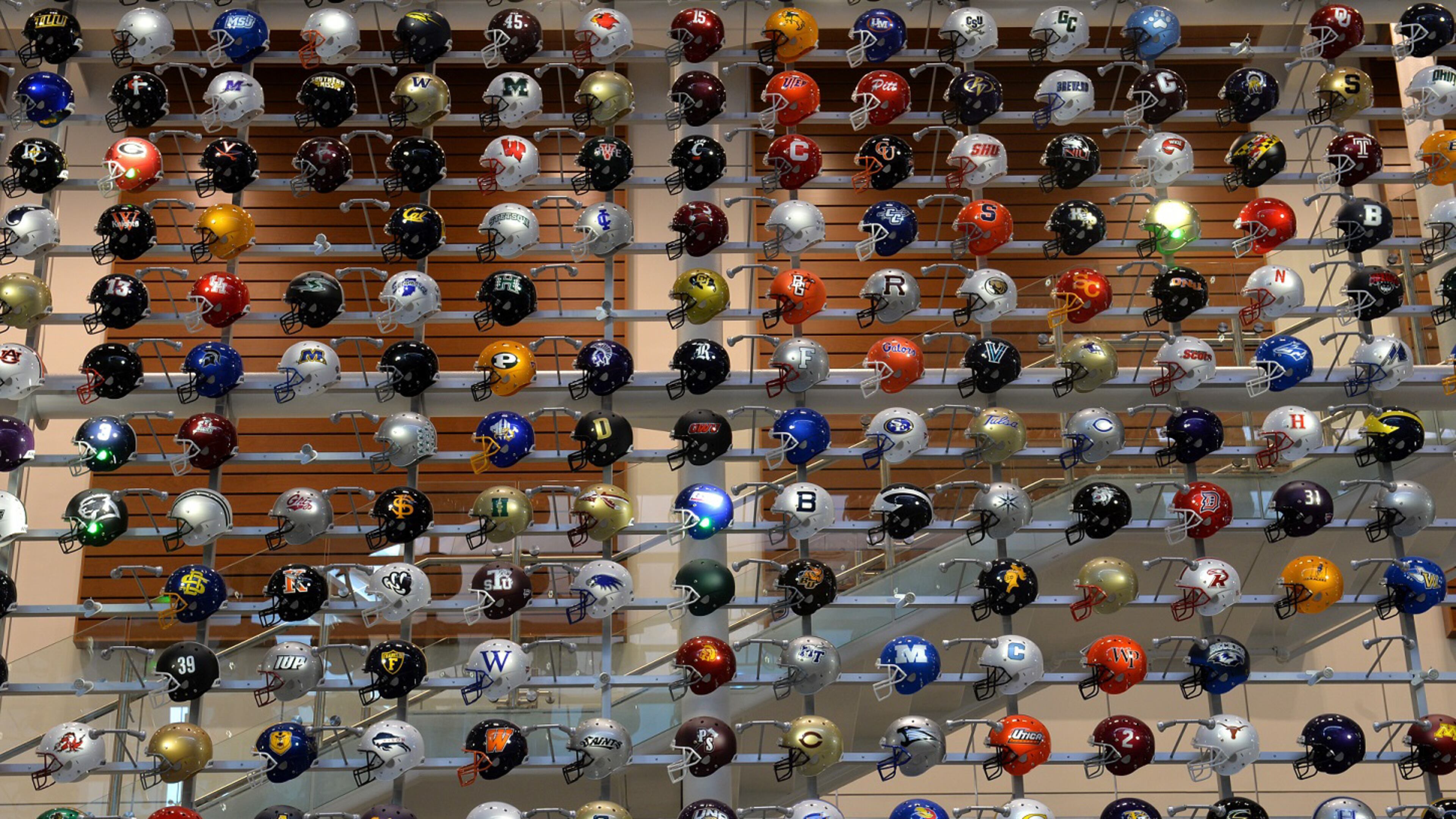Helmets representing college football teams from across the country are on display at the College Football Hall of Fame. (AJC file photo)