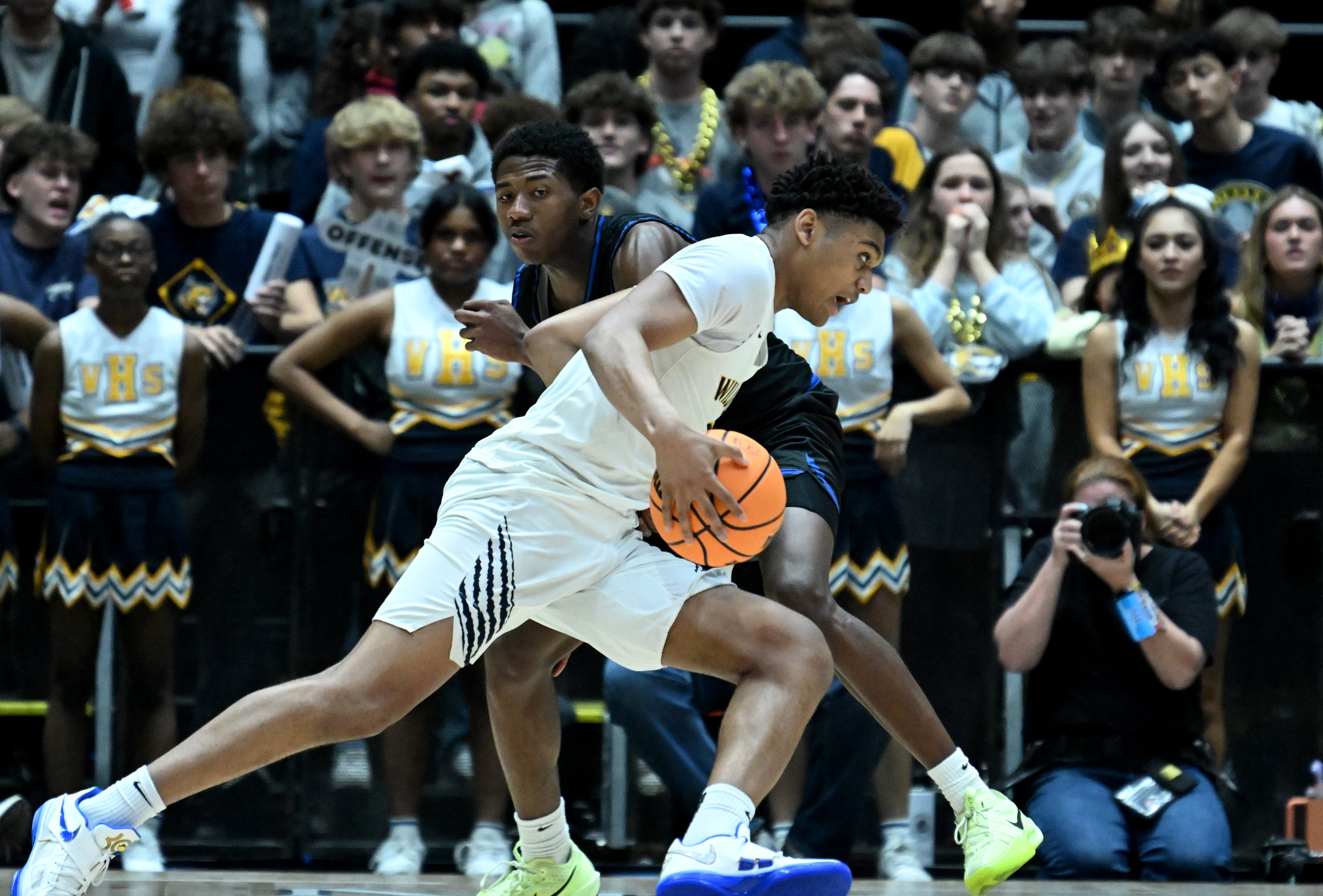 Wheeler's Colben Landrew (foreground) drives against Newton's Davin Neal during the second half of the GHSA Boys 6A State Championship at the Macon Centreplex, Saturday, March 8, 2025, in Macon. Wheeler won 61-56 over Newton. (Hyosub Shin / AJC)