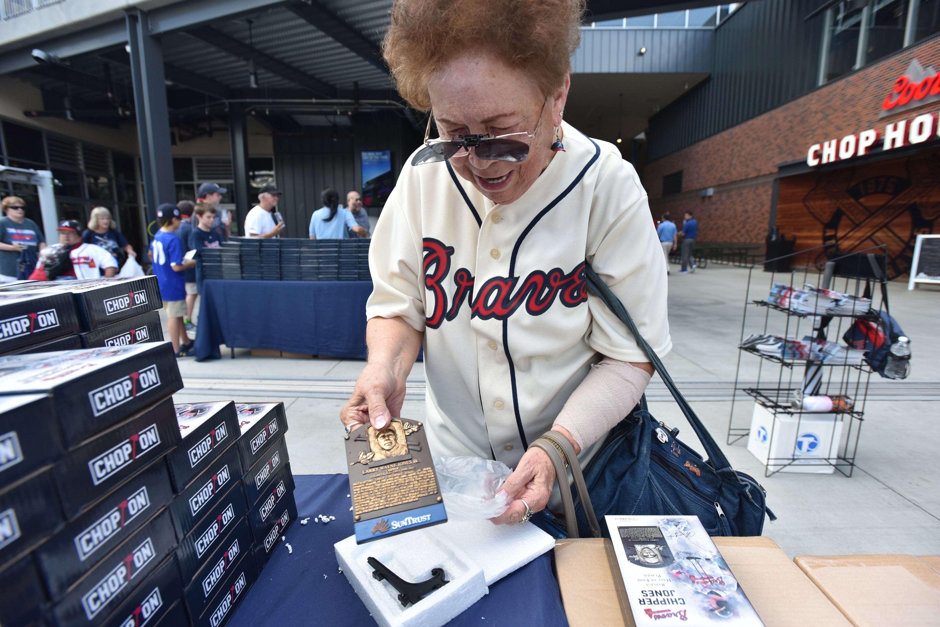 August 10, 2018 Atlanta - Sandy Kinnard holds a Chipper Jones Hall of Fame Replica Plaque before Atlanta Braves home game against the Milwaukee Brewers at the SunTrust Park on Friday, August 10, 2018. The first 20,000 fans in attendance received a Chipper Jones Hall of Fame Replica Plaque The ninth annual Alumni Weekend, which welcomes Braves legends to SunTrust Park for a weekend full of activities. The event will be held this Friday through Sunday as the Braves face the Milwaukee Brewers. HYOSUB SHIN / HSHIN@AJC.COM