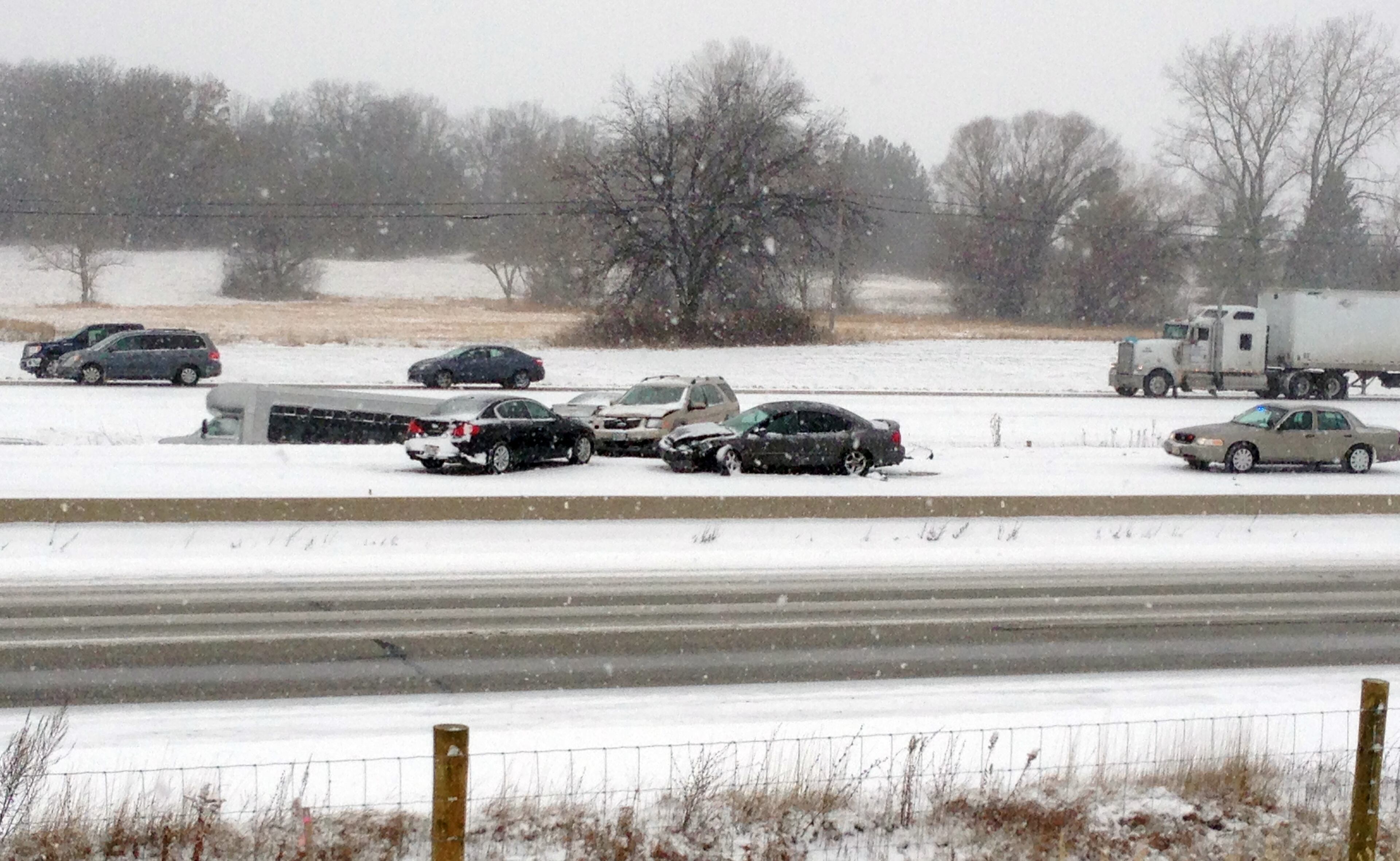 Emergency personnel respond to the scene of an accident on Interstate 94 south of Milwaukee, near Racine, Wis., on Sunday, Dec. 8, 2013. Snow is causing treacherous driving conditions in southeastern Wisconsin. Multiple accidents have been reported on Interstates 94 and 894, as well as I-39 and I-90. The Milwaukee County Sheriff's Office describes conditions as extremely dangerous and slippery, with multiple pileups, including a fatal rollover on I-94 eastbound at Highway 100. (AP Photo/Michelle L Johnson)