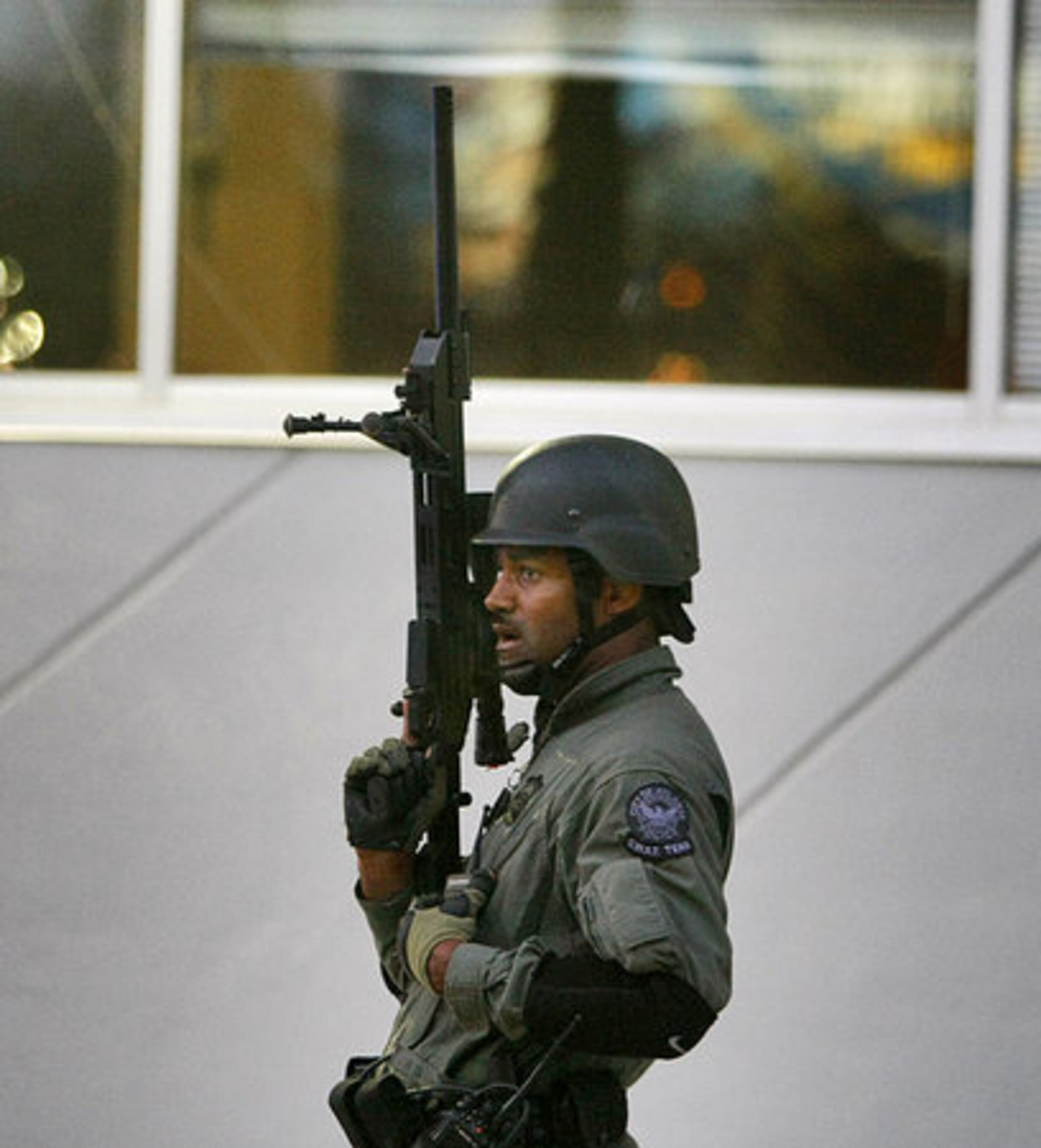 APD SWAT officer waits behind the 1776 Peachtree Building Thursday.