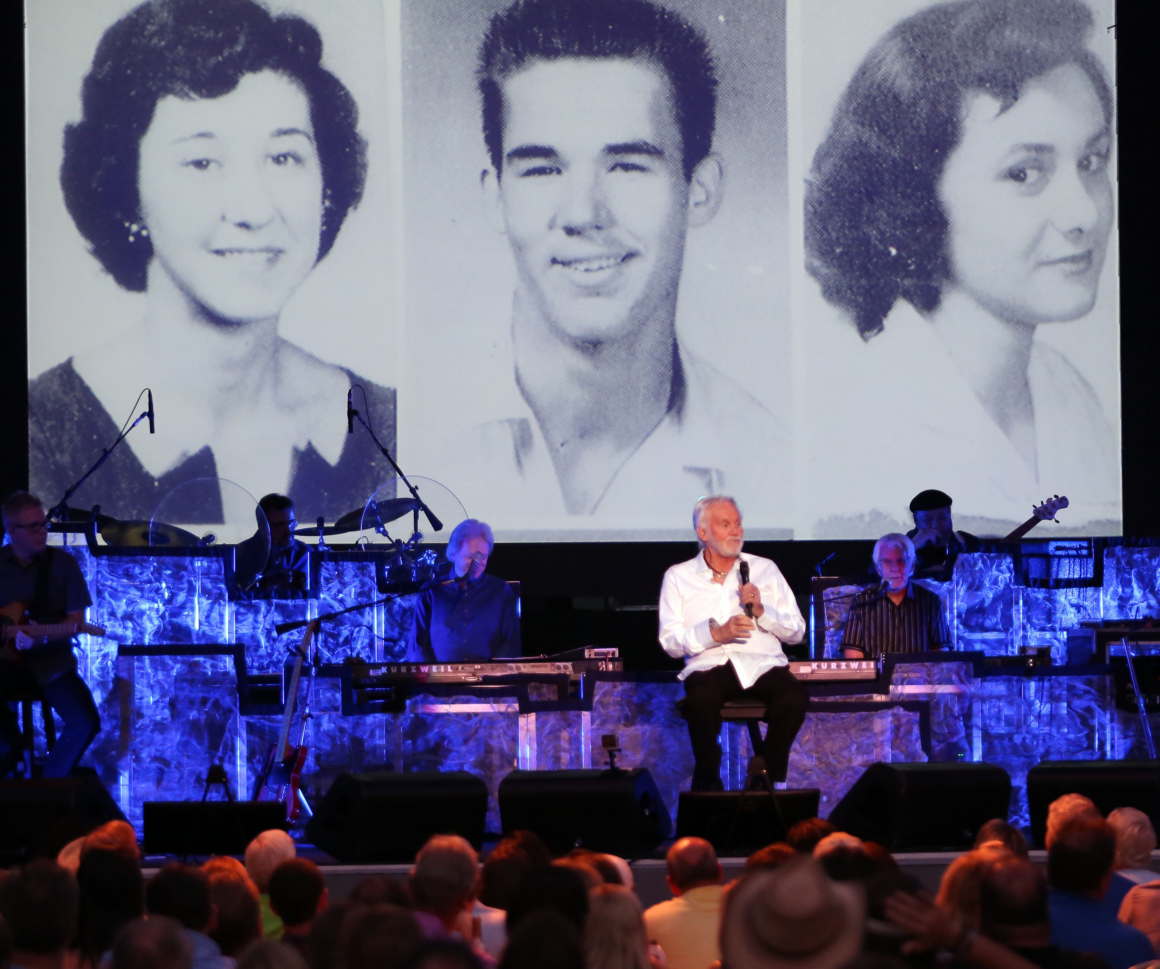 June, 19, 2016- ATLANTA: Kenny Rogers with a backdrop of photos from his high school days, regals the audience with stories of the beginnings of his career. (Akili-Casundria Ramsess/Special to the AJC)