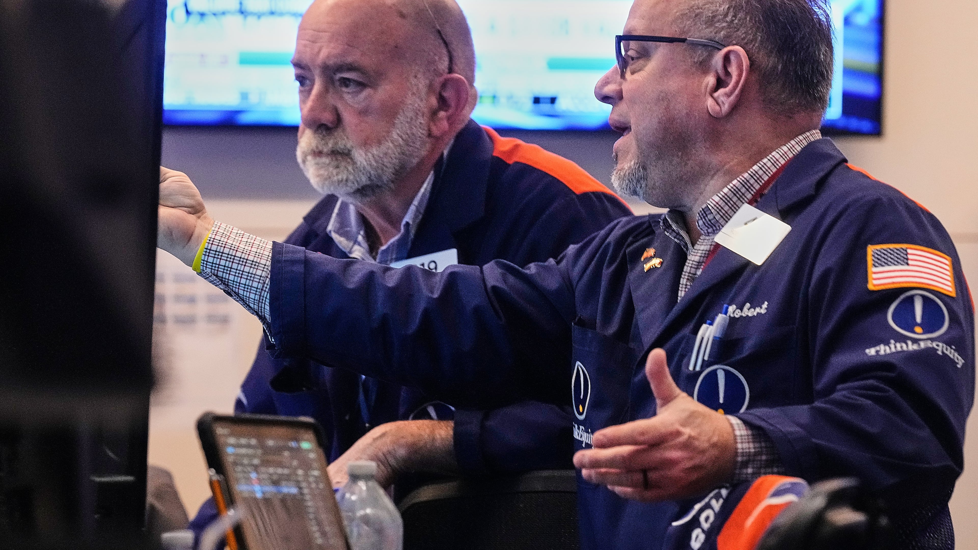 FILE - Traders Joseph Stevens, left, and Robert Arciero work on the floor of the New York Stock Exchange, Monday, Feb. 2, 2026. (AP Photo/Richard Drew, file)