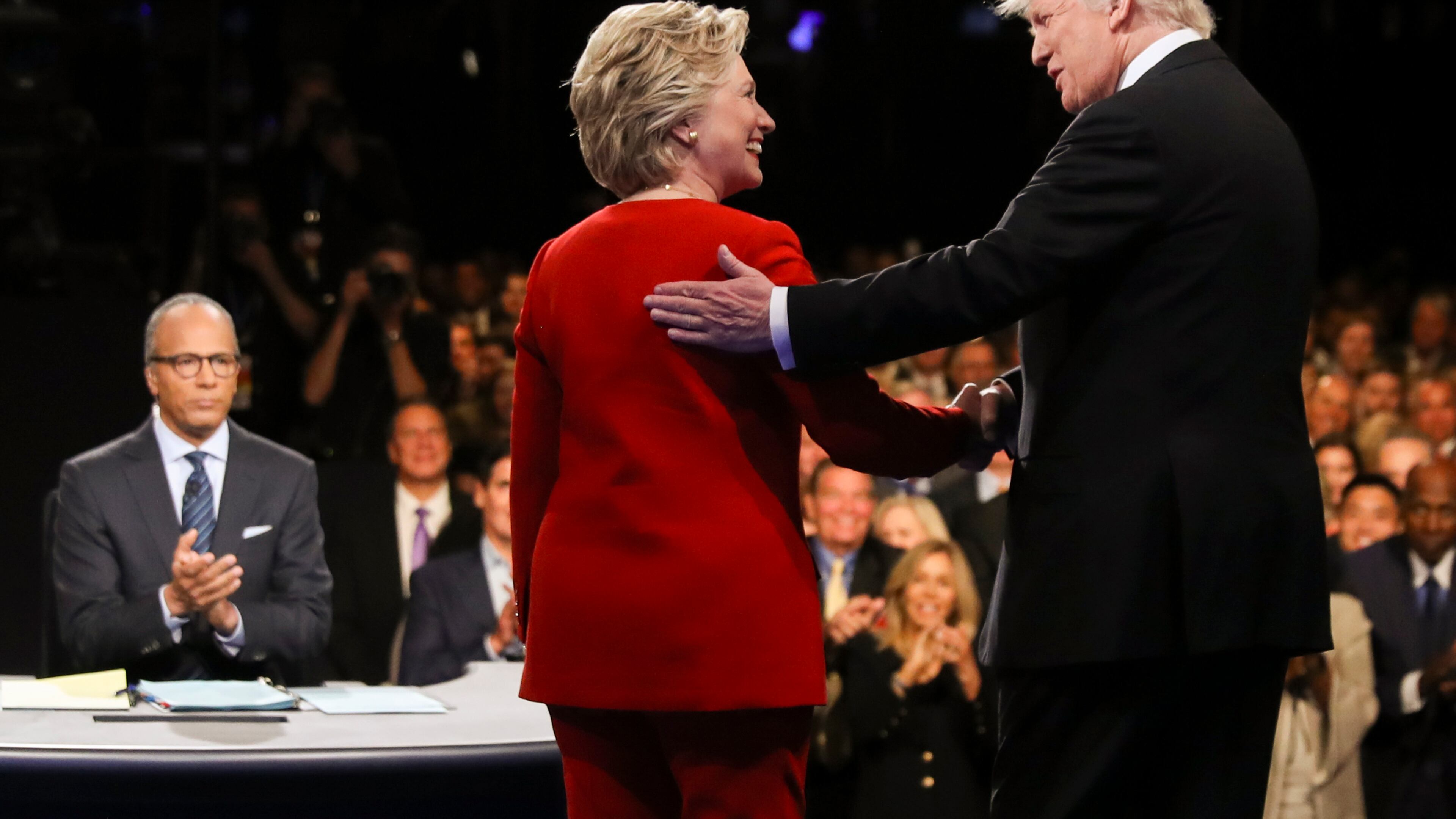 FILE - In this Sept. 26, 2016 file photo, Democratic presidential nominee Hillary Clinton and Republican presidential nominee Donald Trump shake hands during the presidential debate at Hofstra University in Hempstead, N.Y. For presidential candidates, the town hall debate is a test of stagecraft as much as substance. When Hillary Clinton and Donald Trump meet in the Sunday, Oct.9, 2016, contest, they’ll be fielding questions from undecided voters seated nearby. In an added dose of unpredictability, the format allows the candidates to move around the stage, putting them in unusually close proximity to each other. (Joe Raedle/Pool via AP, File)