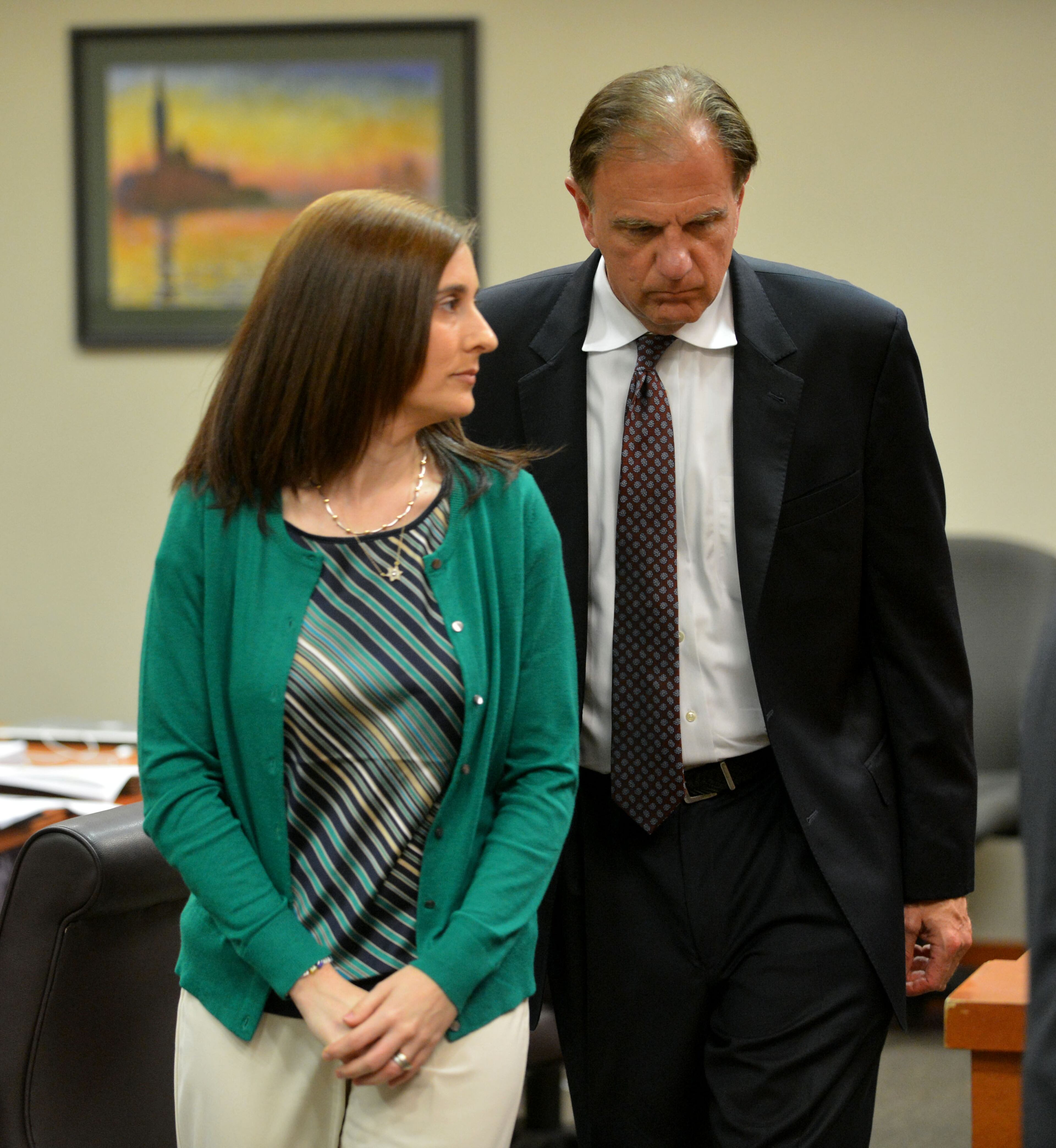 Andrea Sneiderman leaves the courtroom during a break in court Friday. Dekalb County Superior Court Judge Gregory A. Adams presided over a pre-trial hearing for Andrea Sneiderman Friday, July 26, 2013.