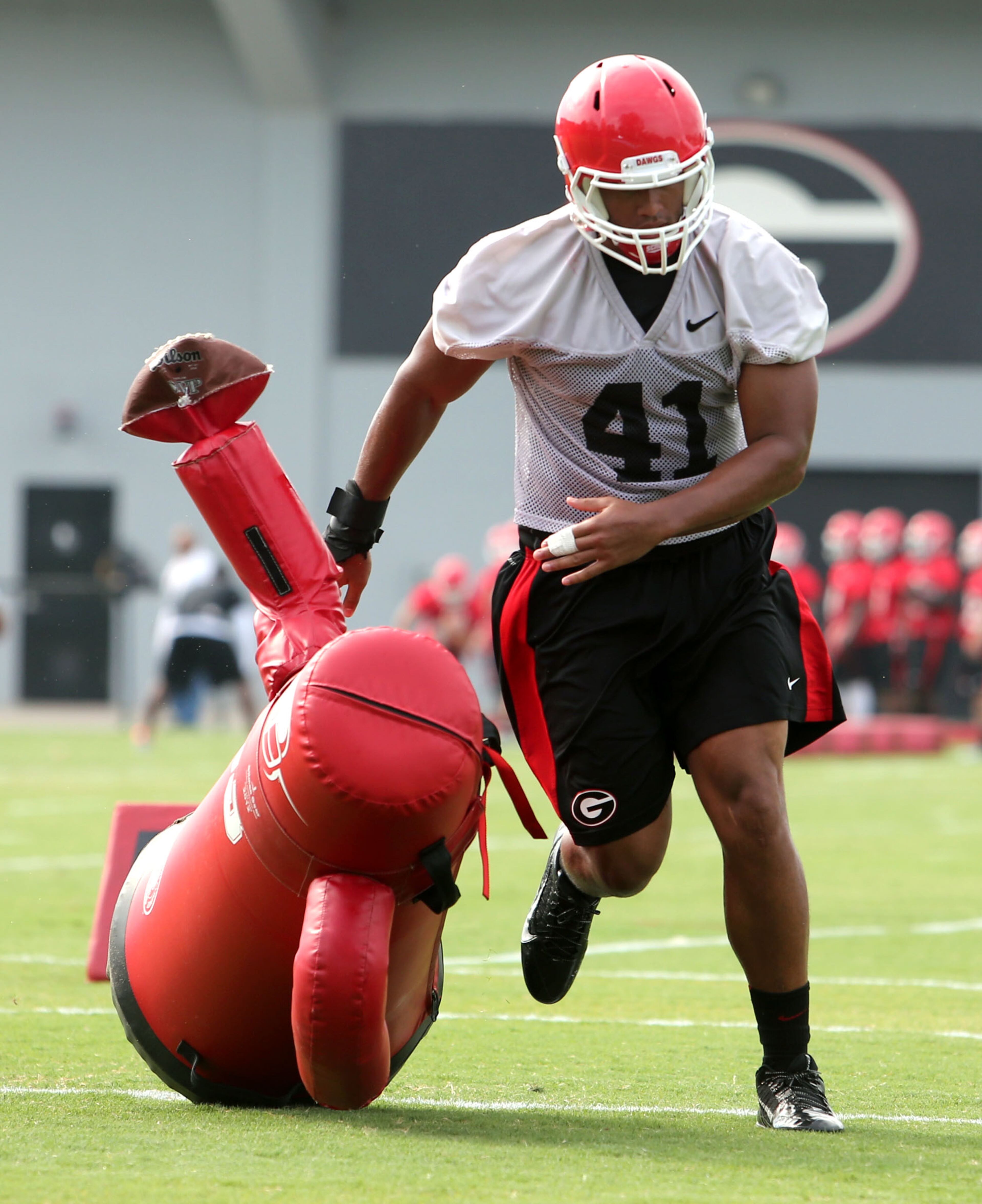 University of Georgia outside linebacker Brandon Burrows (41) participates in a drill during preseason practice at the University of Georgia Tuesday afternoon in Athens, Ga., August 6, 2013. Burrows is a junior from Walton High School. JASON GETZ / JGETZ@AJC.COM