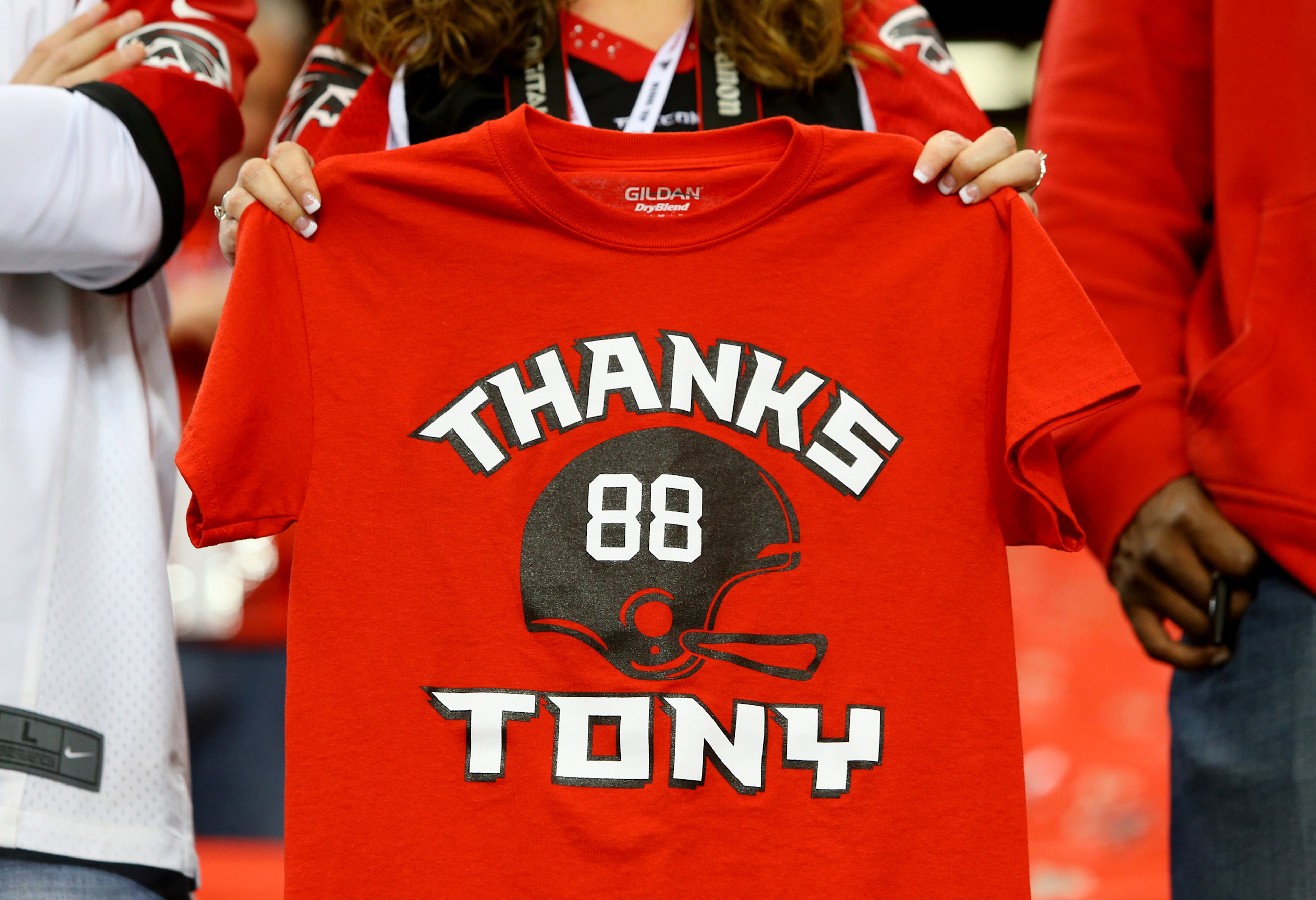 Sidney Sears, Gainesville, holds out the front of her shirt in support of Falcons tight end Tony Gonzalez while he takes the field for the final game of his 17-year NFL career on Sunday, Dec. 29, 2013, in Atlanta.