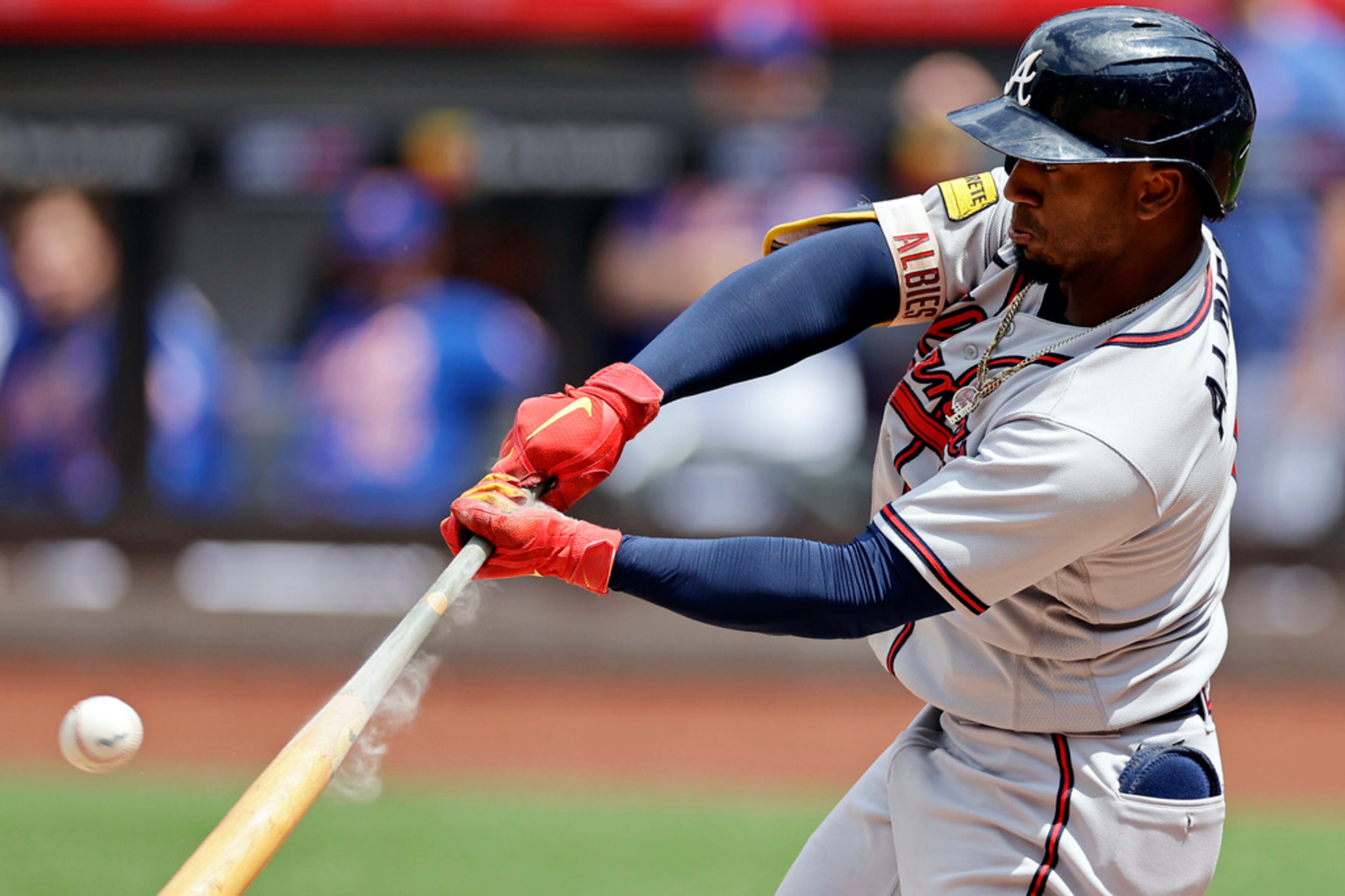 Atlanta Braves' Ozzie Albies flies out to end the top half of the second inning against the New York Mets in the first baseball game of a doubleheader on Saturday, Aug. 12, 2023, in New York. (AP Photo/Adam Hunger)