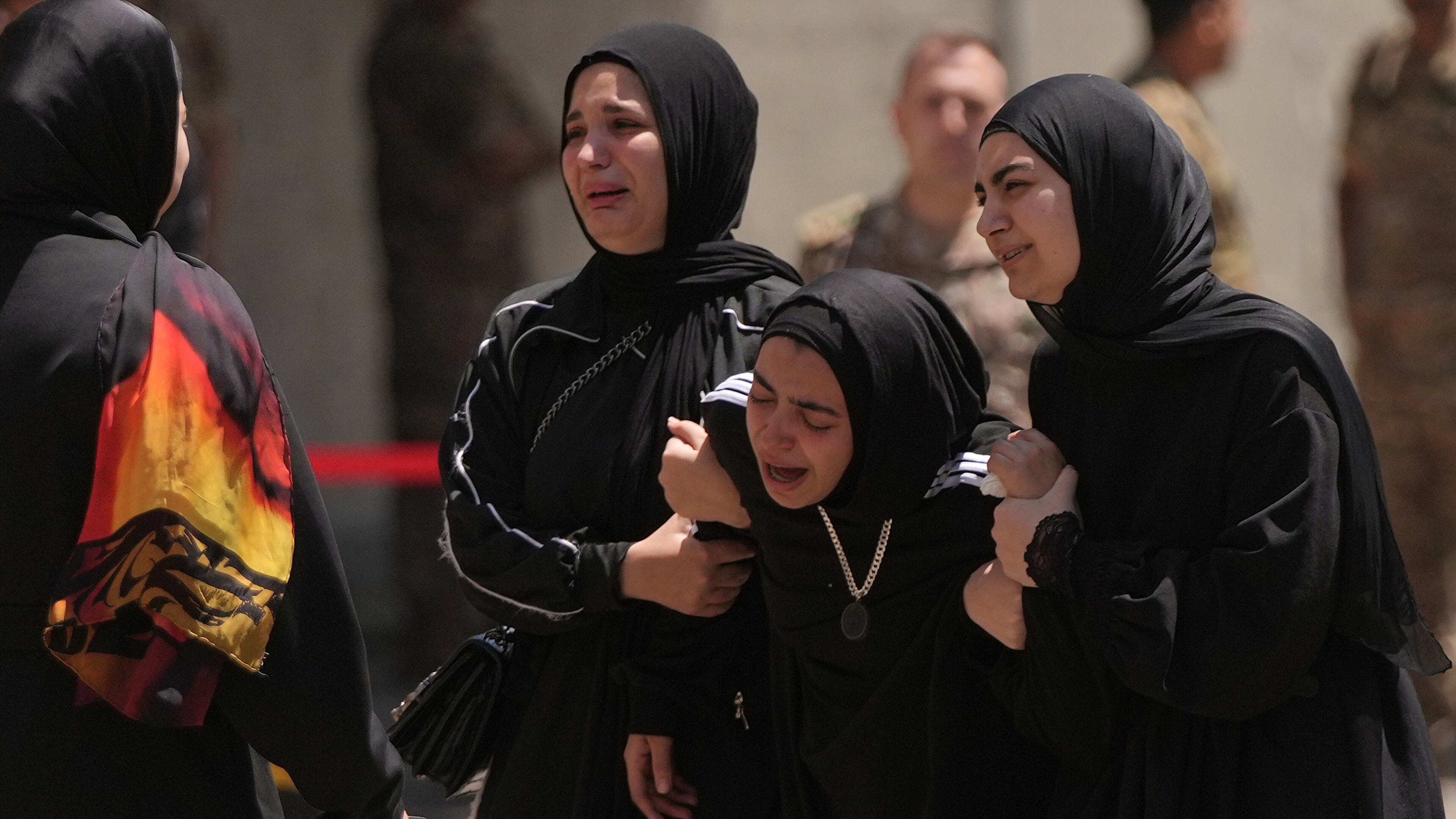 Relatives of the Lebanese soldier Hussein Nazzal, who was killed Saturday in south Lebanon along with a brigadier general and a captain in an Israeli airstrike, mourn during his funeral procession in Beirut, Sunday, June 7, 2026. (AP Photo/Hassan Ammar)