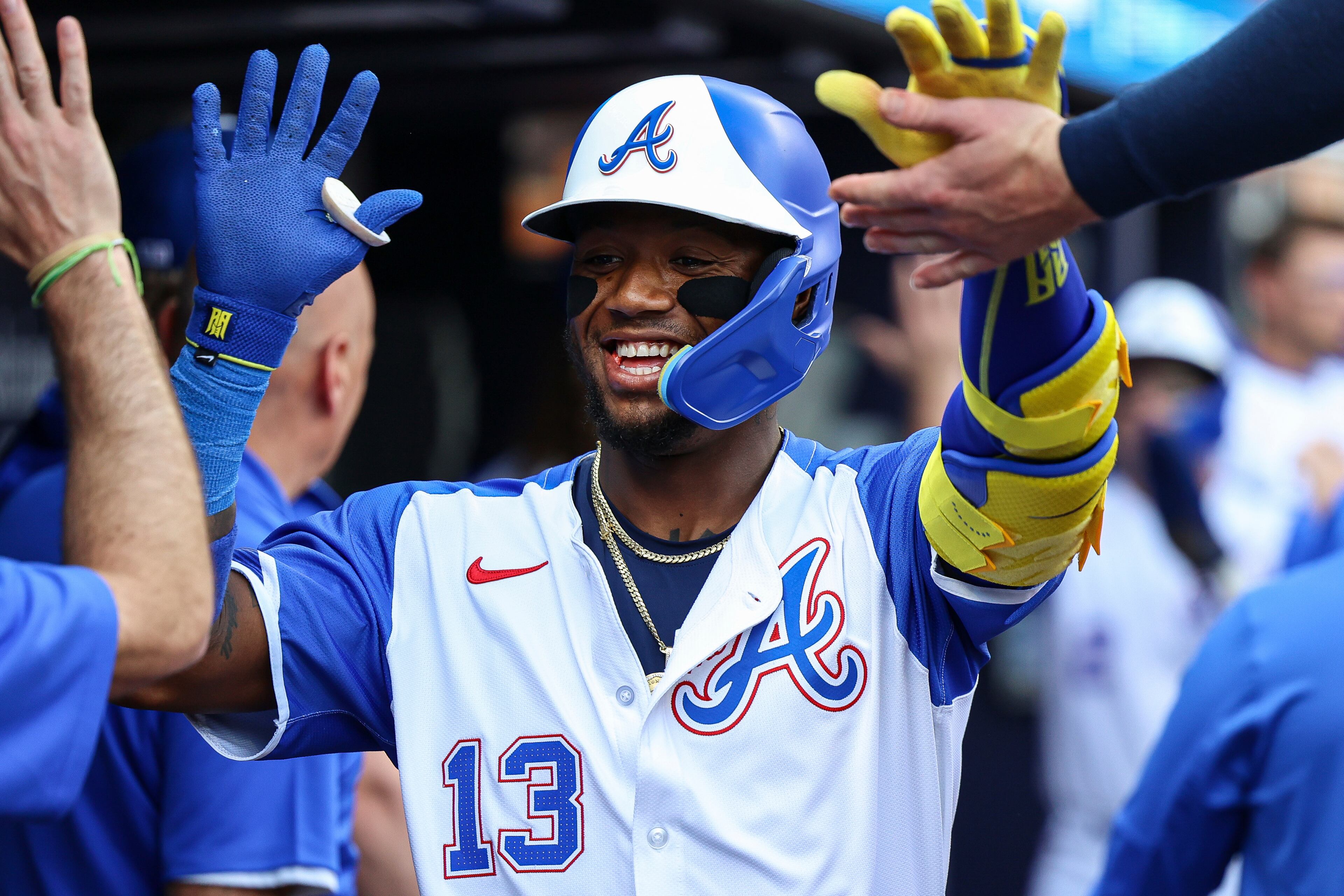 Atlanta Braves' Ronald Acuna Jr. (13) high-fives teammates in the dugout after hitting a two-run home run in the sixth inning of a baseball game against the San Diego Padres, Saturday, May 24, 2025, in Atlanta. (AP Photo/Colin Hubbard)