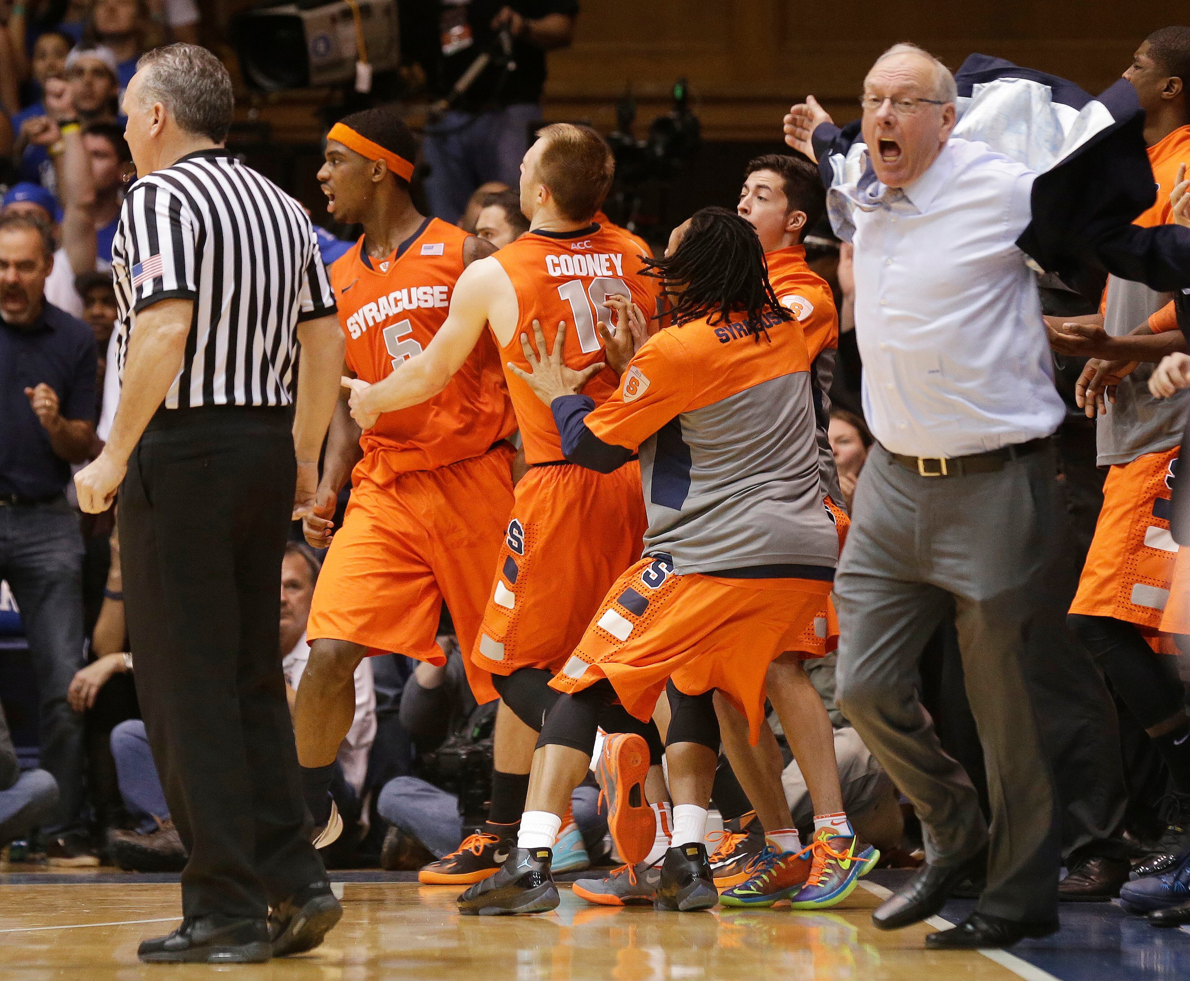 Syracuse coach Jim Boeheim, right, and players react to an official's call of a charge against C.J. Fair late in the second half of an NCAA college basketball game against Duke in Durham, N.C., Saturday, Feb. 22, 2014. Duke won 66-60. (AP Photo/Gerry Broome)