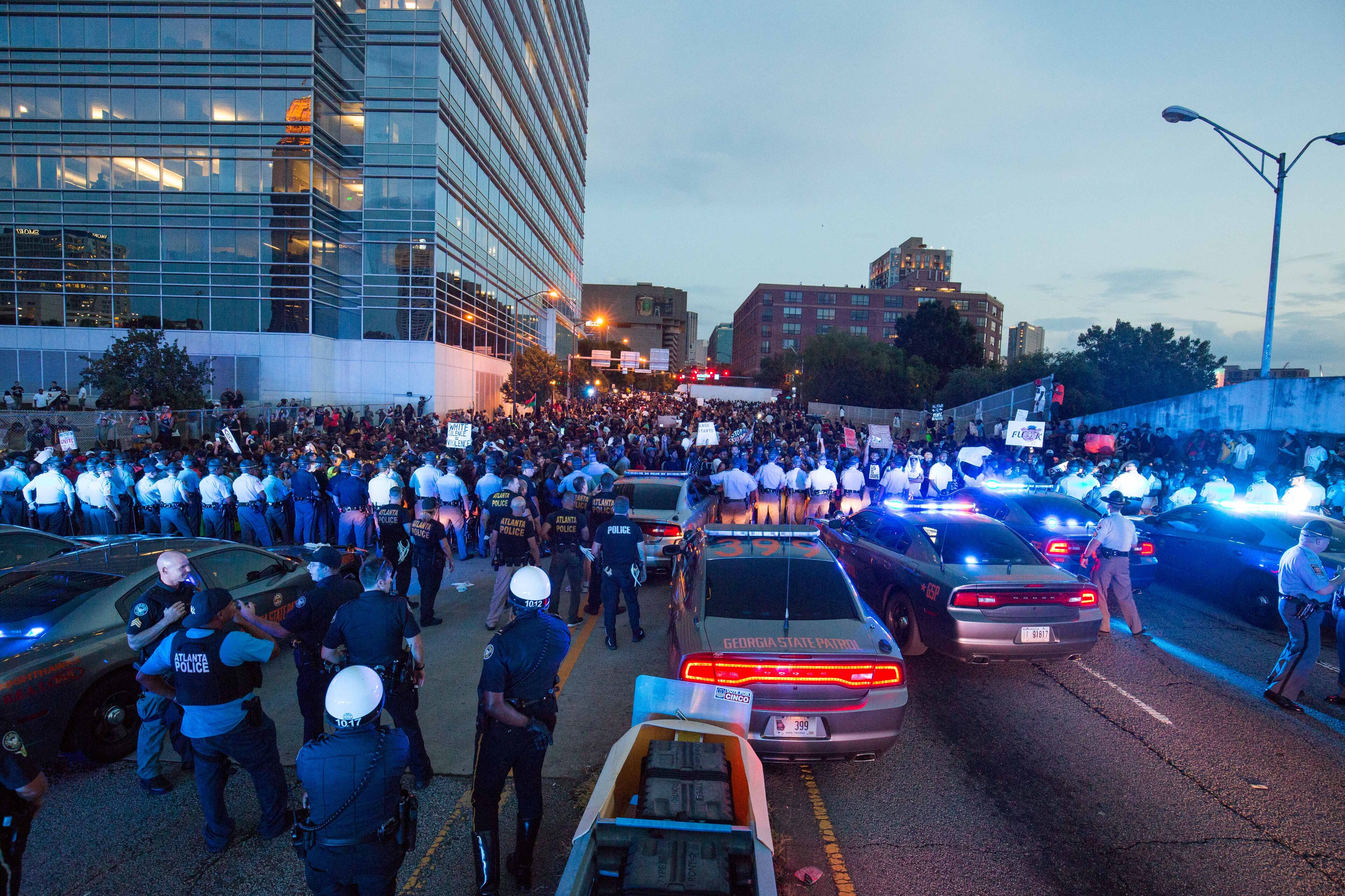 Officers standoff with demonstrators at the I-75/85 Williams Street exit, Friday, July 8, 2016. Demonstrators gathered following the deaths of Alton Sterling, 37, who was killed by Baton Rouge police outside of a convenience store where he was selling CDs, and Philando Castile, who was shot and killed when Minnesota police stopped him for a traffic violation on Wednesday evening.