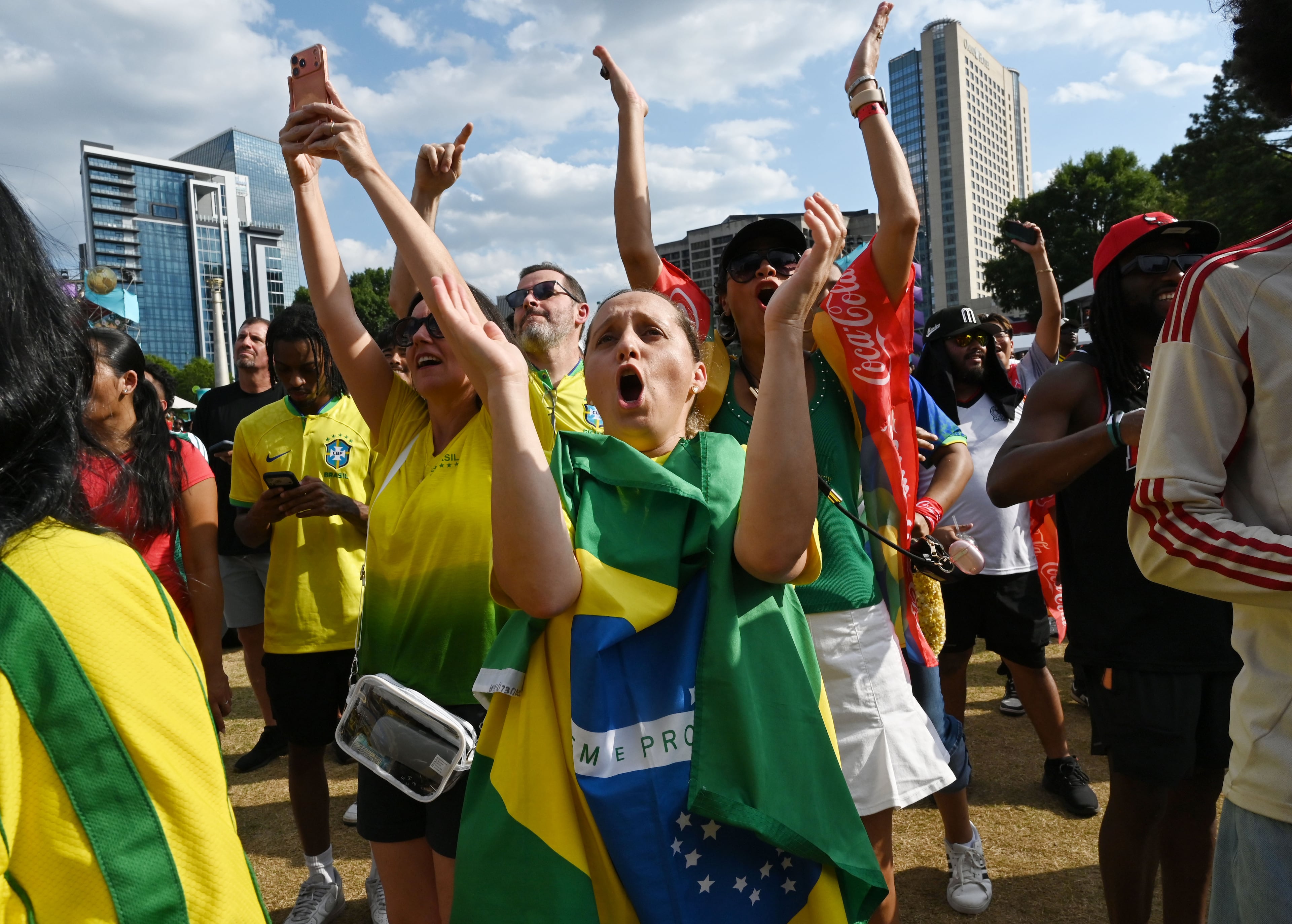 Brazil fans cheer as they gather to watch the match between Brazil vs. Scotland at the FIFA Fan Festival in Centennial Olympic Park on Wednesday, June 24, 2026, in Atlanta. (Hyosub Shin/AJC)