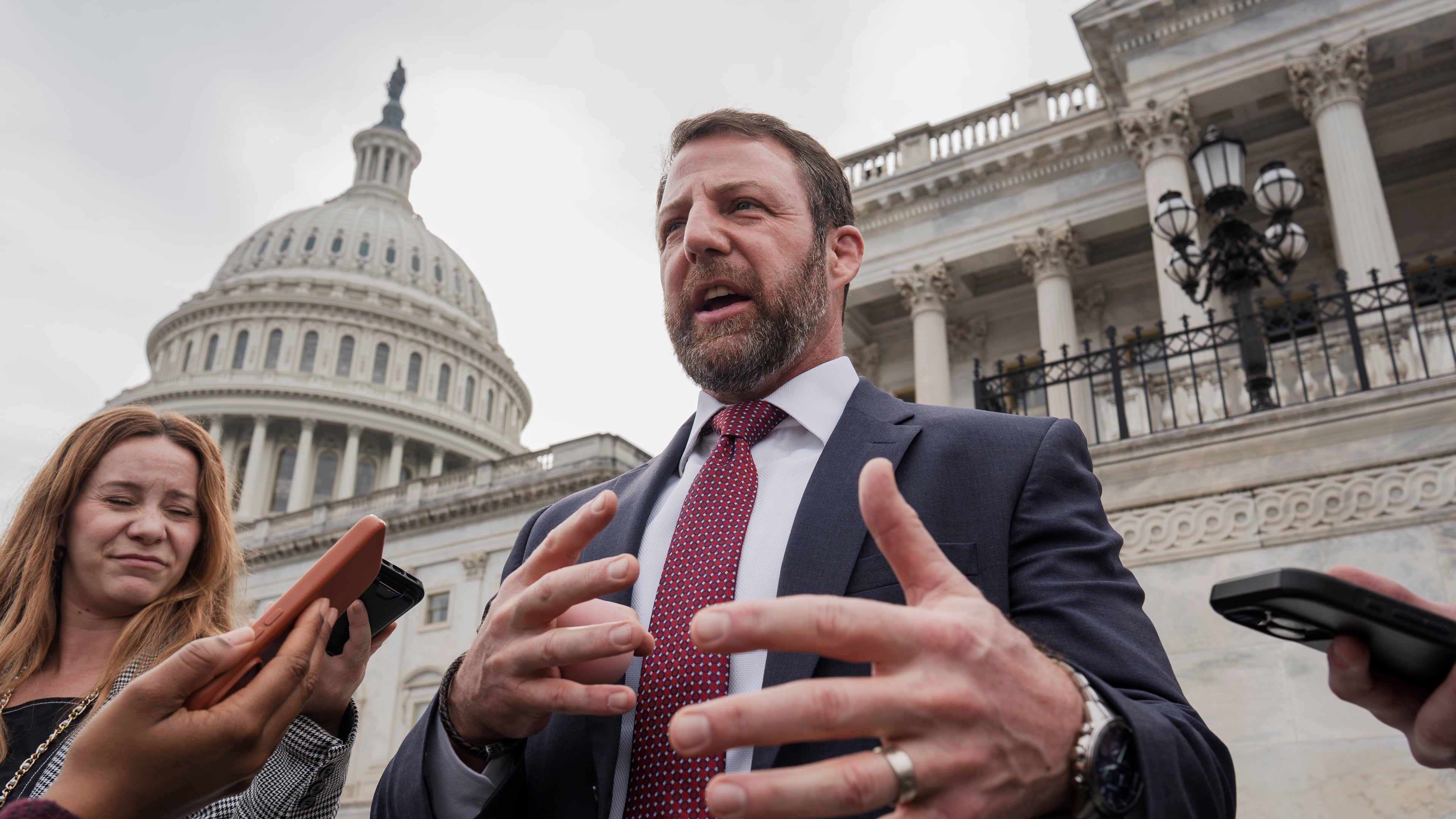 FILE - Sen. Markwayne Mullin, R-Okla., speaks with reporters on the steps at the Capitol in Washington, Thursday, March 5, 2026. (AP Photo/J. Scott Applewhite, File)