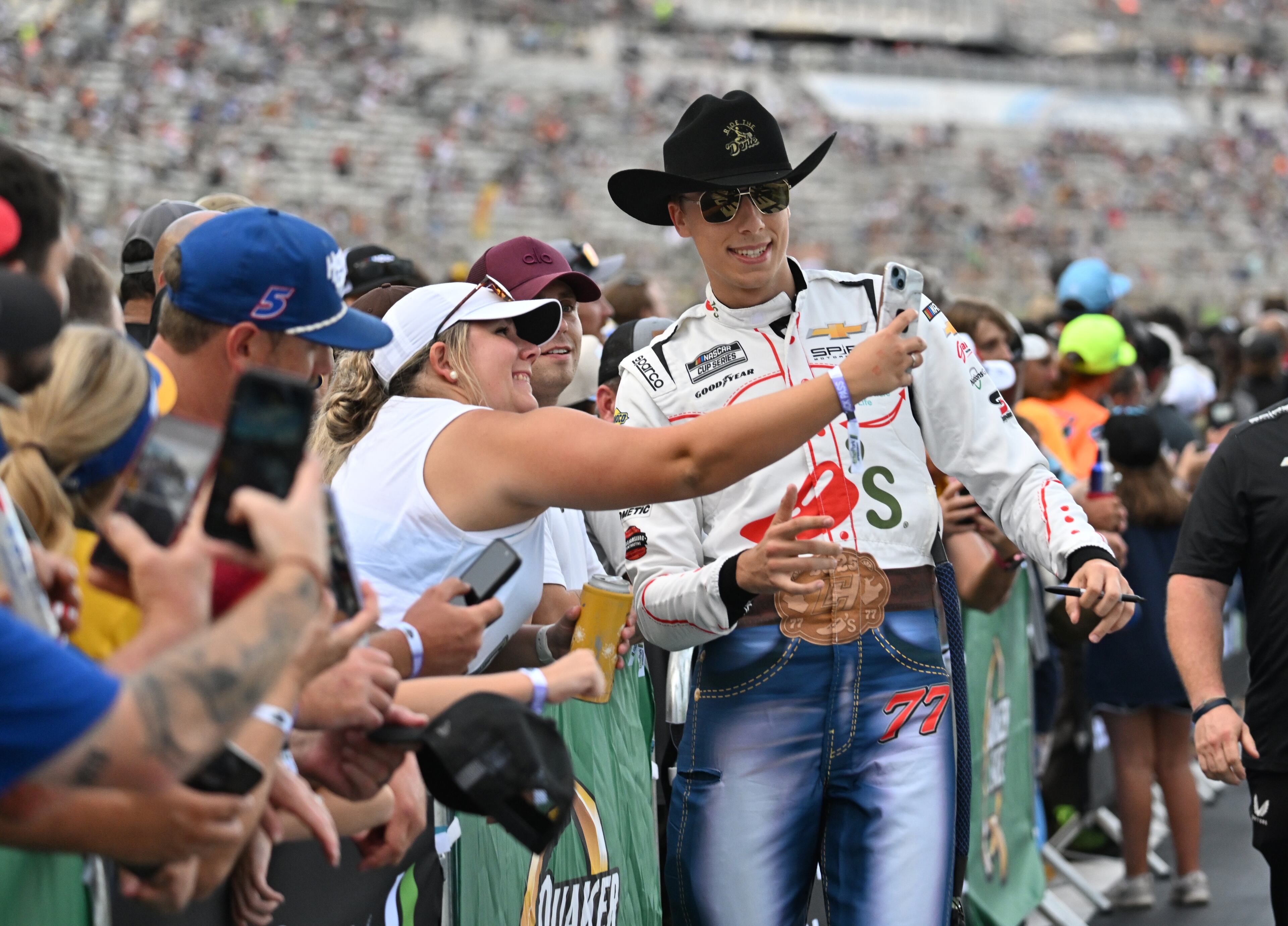 NASCAR Cup Series driver Carson Hocevar poses with a fan before Quaker State 400 NASCAR Cup Series race at EchoPark Speedway, Saturday, June 28, 2025, in Hampton. (Hyosub Shin / AJC)