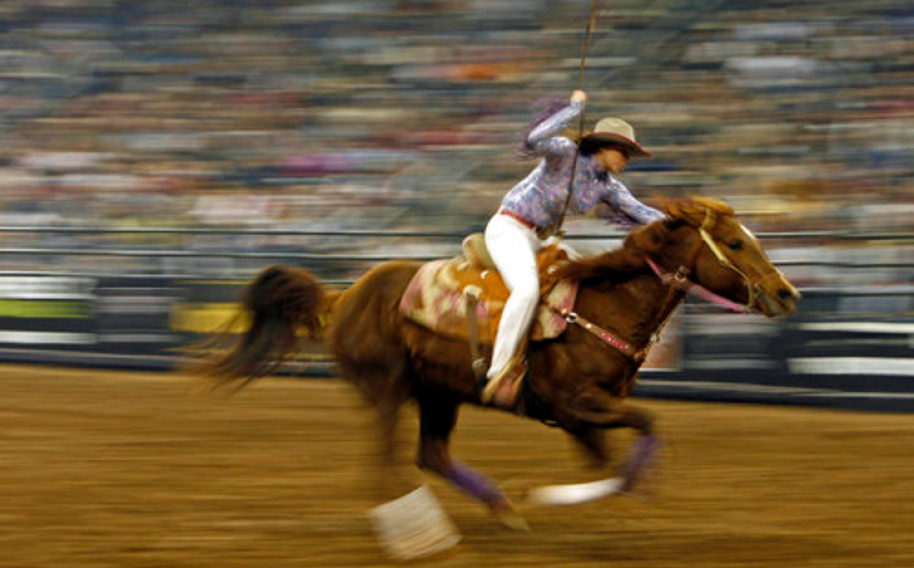 Michelle Sims speeds to the finish line as she finishes first during the Barrel Racing portion of the competition.