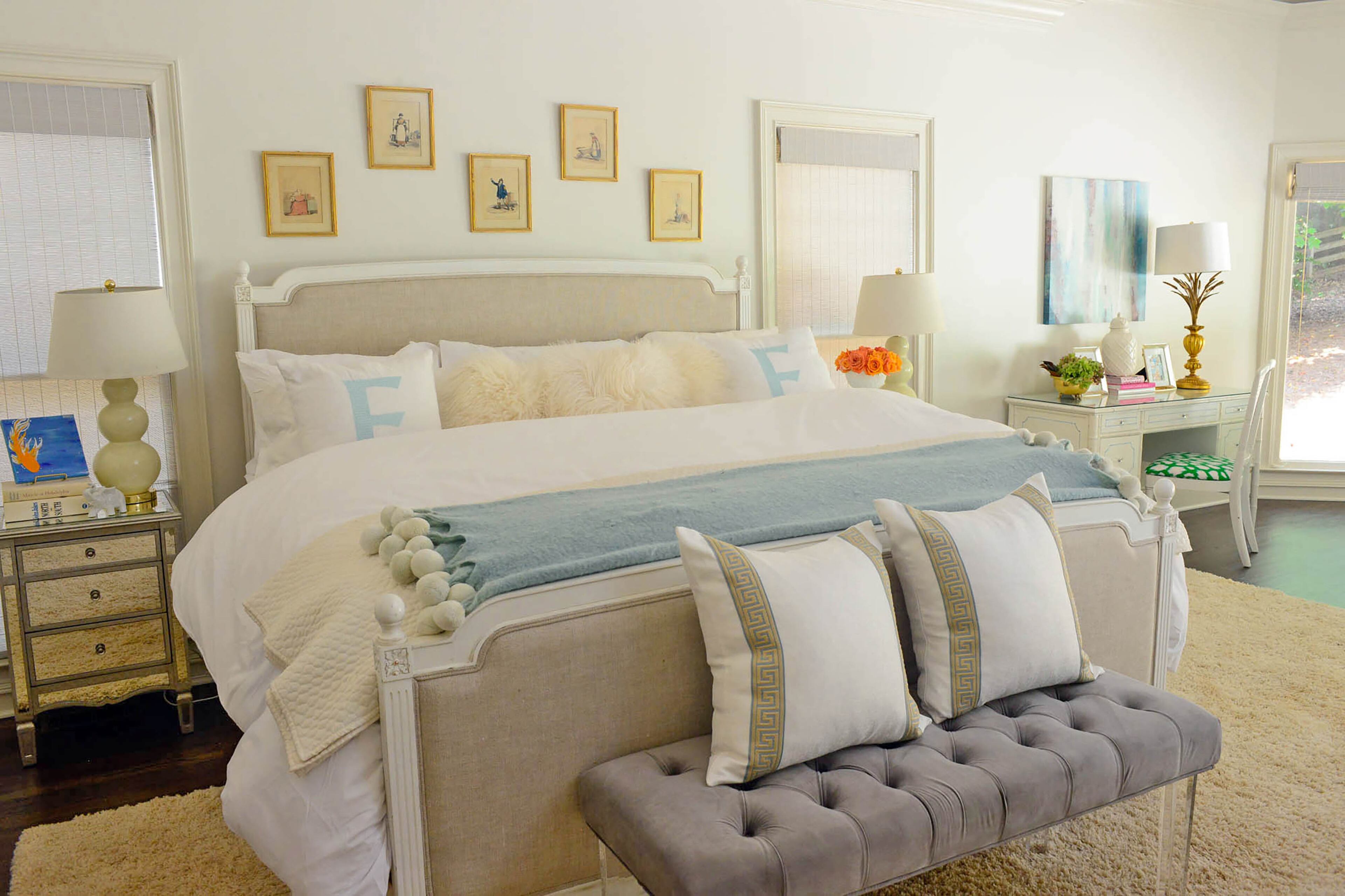 Beachy decor, including bamboo elements in her desk and chair, mix seamlessly with subtle hues in the master bedroom. Above the bed are five hand-colored antique framed book plates. Rounded gourd lamps from Wayfair frame the bed.