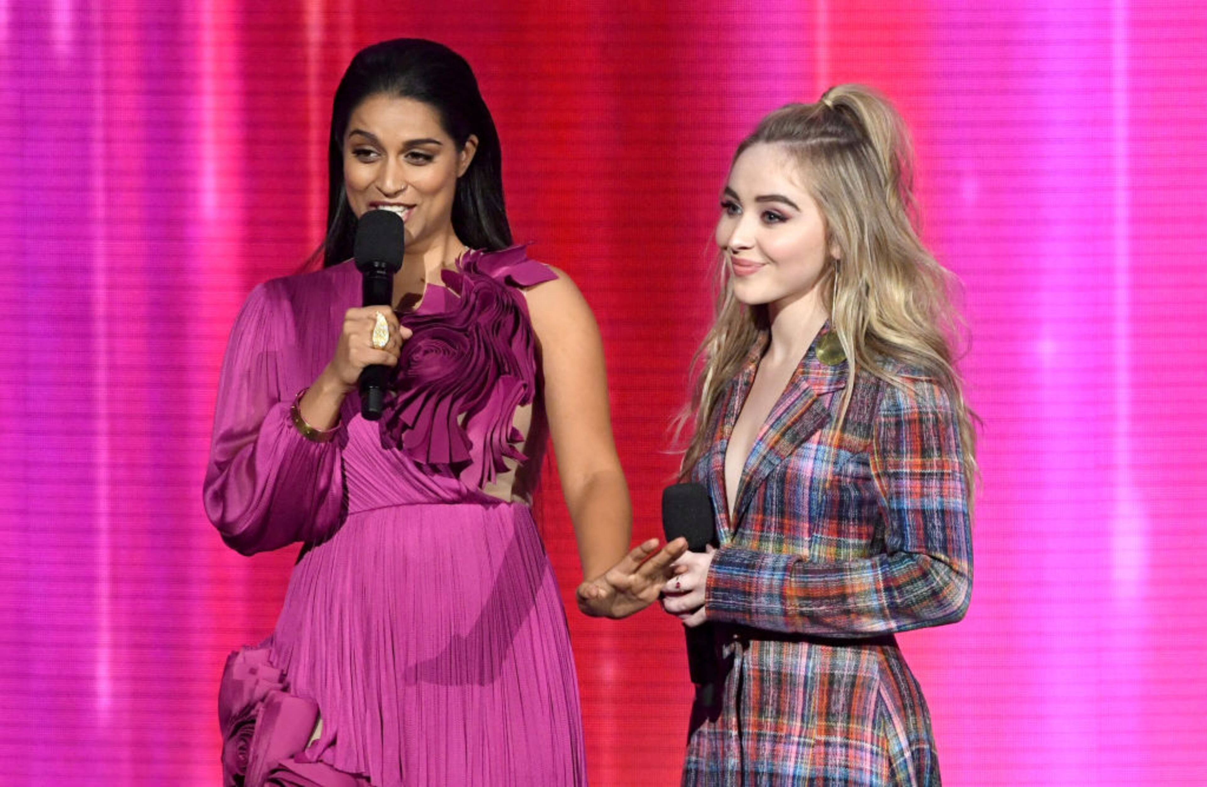 LOS ANGELES, CA - NOVEMBER 19: Lilly Singh (L) and Sabrina Carpenter speak onstage during the 2017 American Music Awards at Microsoft Theater on November 19, 2017 in Los Angeles, California. (Photo by Kevin Winter/Getty Images)