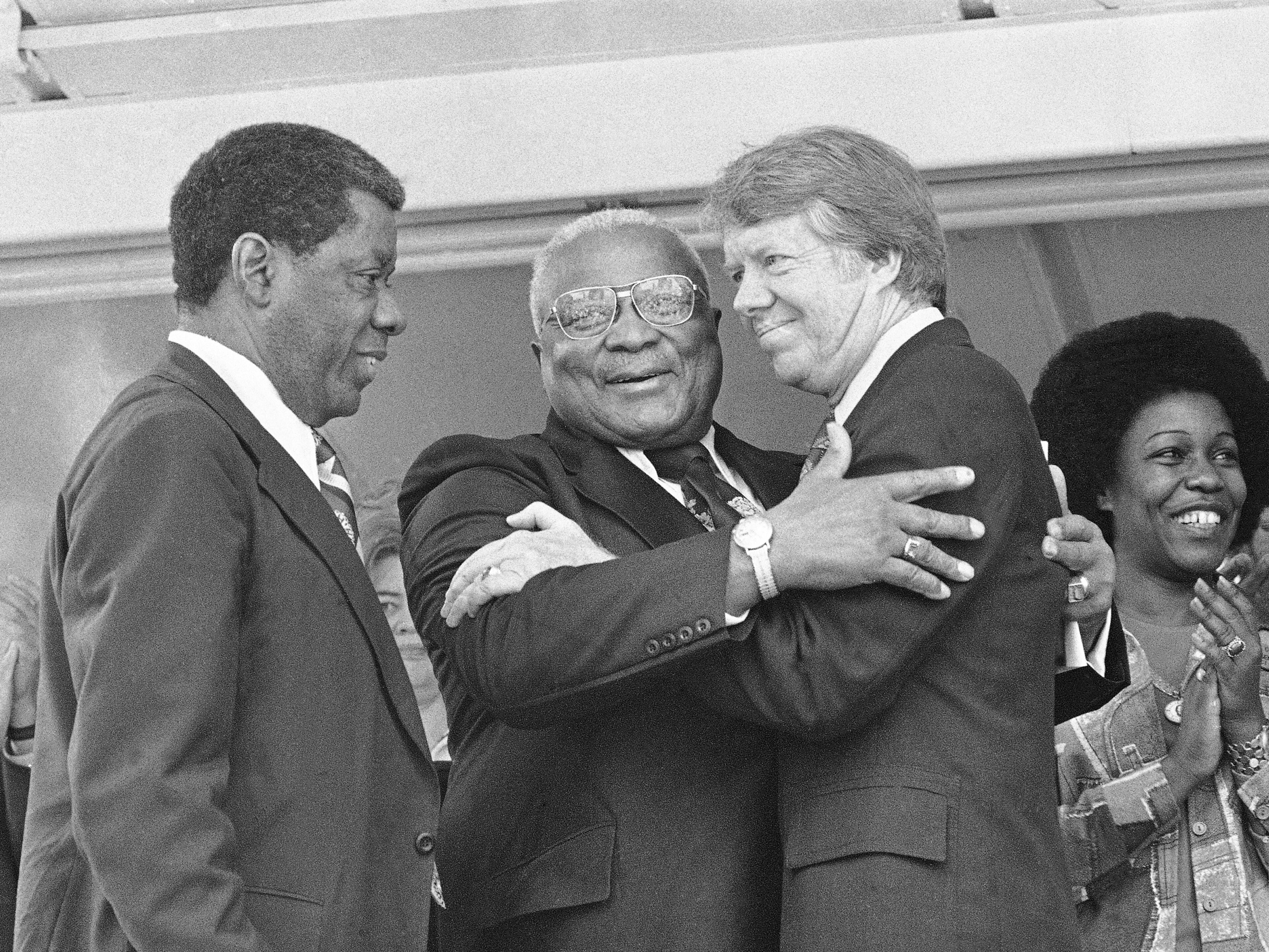 The Rev. Dr. Martin Luther King Sr., center, and Democratic presidential hopeful Jimmy Carter, right, embrace during a campaign rally where King declared, "I love and believe in him,"; April 13, 1976, in Atlanta, Ga.
In a prepared speech read by Atlanta businessman Jesse Hill, left, King said Carter has been for equal justice when it wasn't an easy thing to be for in South Georgia. Carter has been under sharp criticism from some Black leaders since his statement on ethnic purity. (AP Photo)