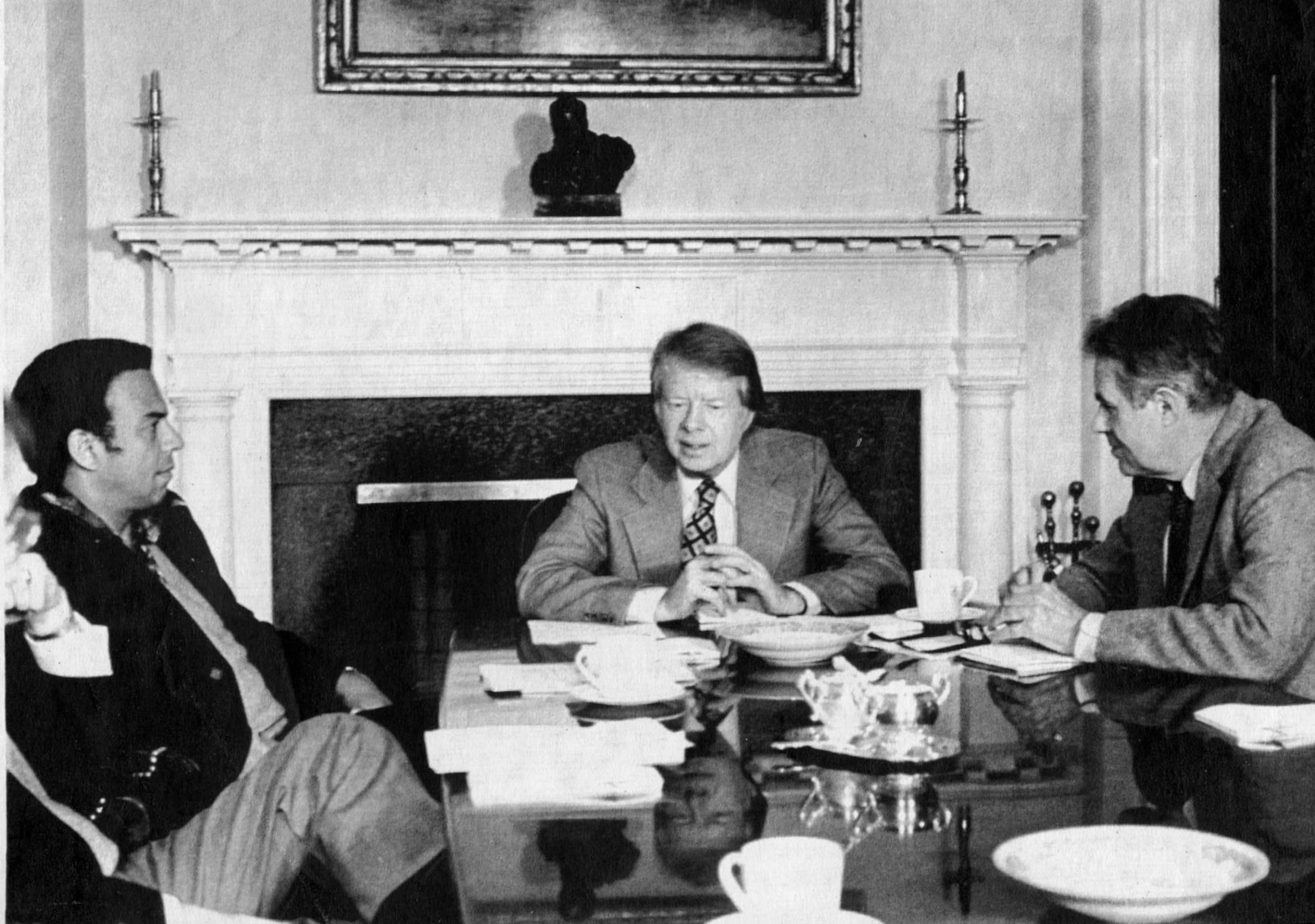 One hundred days into his term, President Jimmy Carter confers with Ambassador Young, left, and U.S. Secretary of State Cyrus Vance at the White House on April 30, 1977. (UPI)