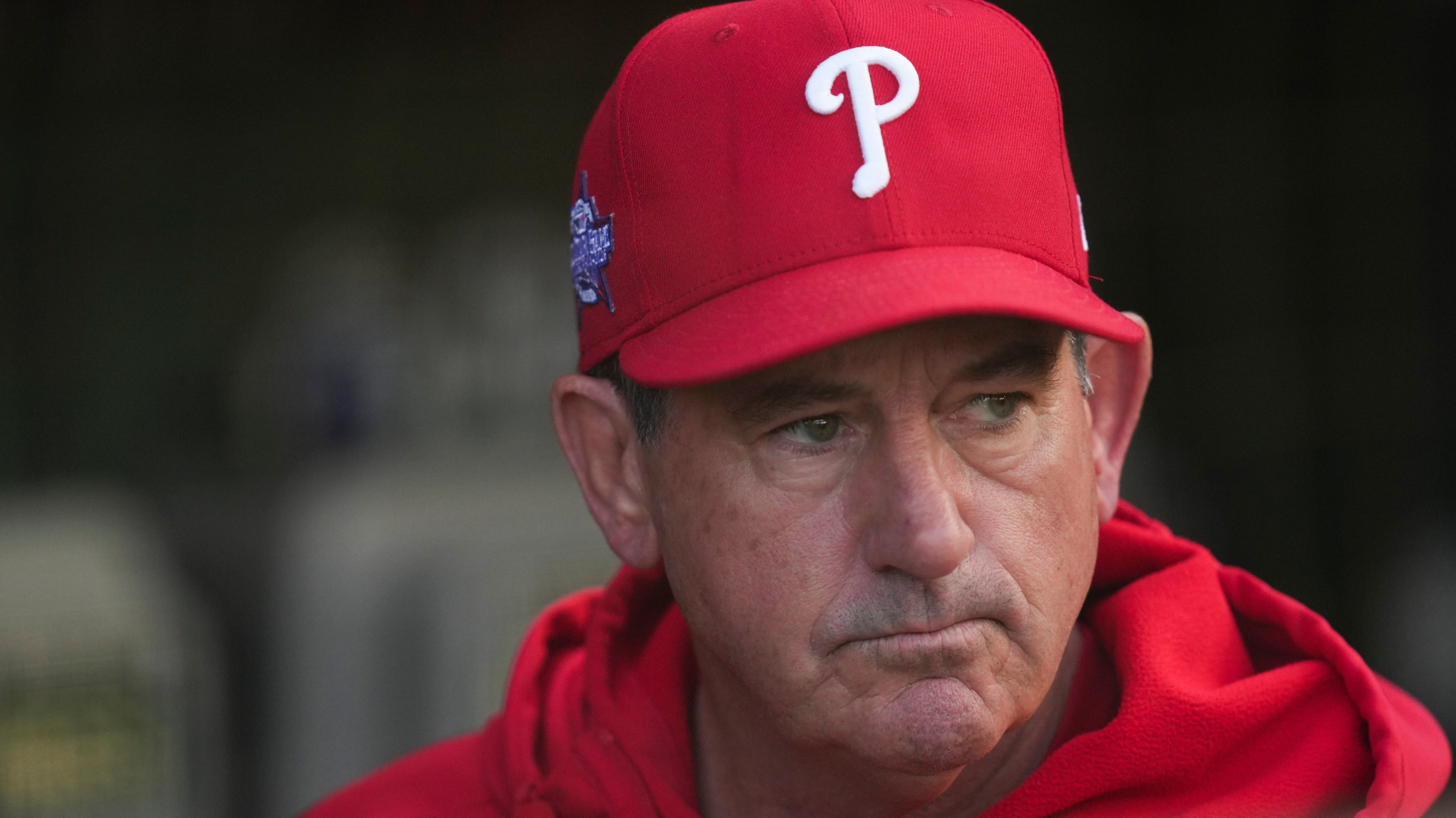 Philadelphia Phillies manager Rob Thomson (49) stands in the dugout before a baseball game against the Chicago Cubs, Wednesday, April 22, 2026, in Chicago. (AP Photo/Erin Hooley)